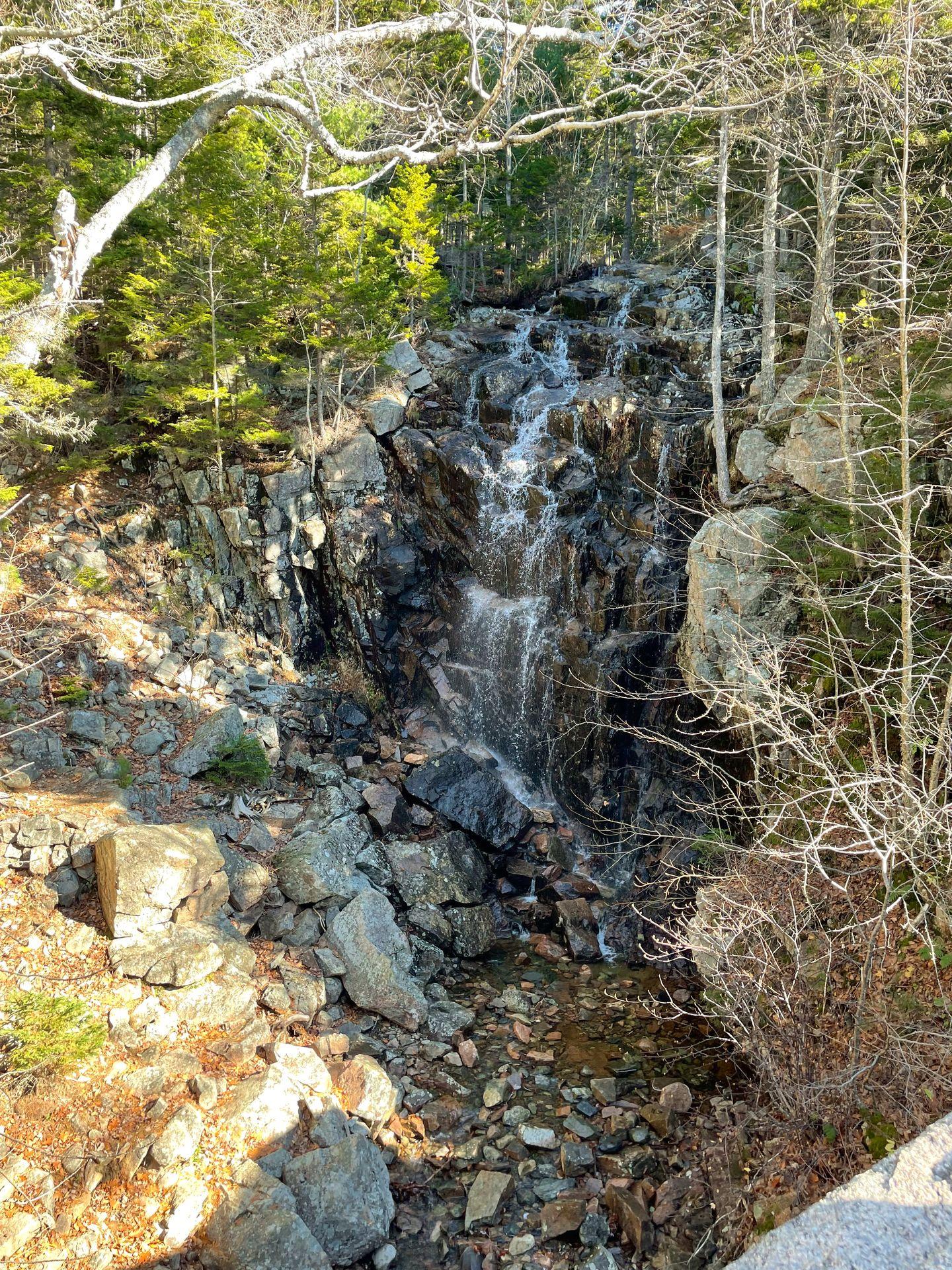 A small waterfall right next to a Carriage Road.