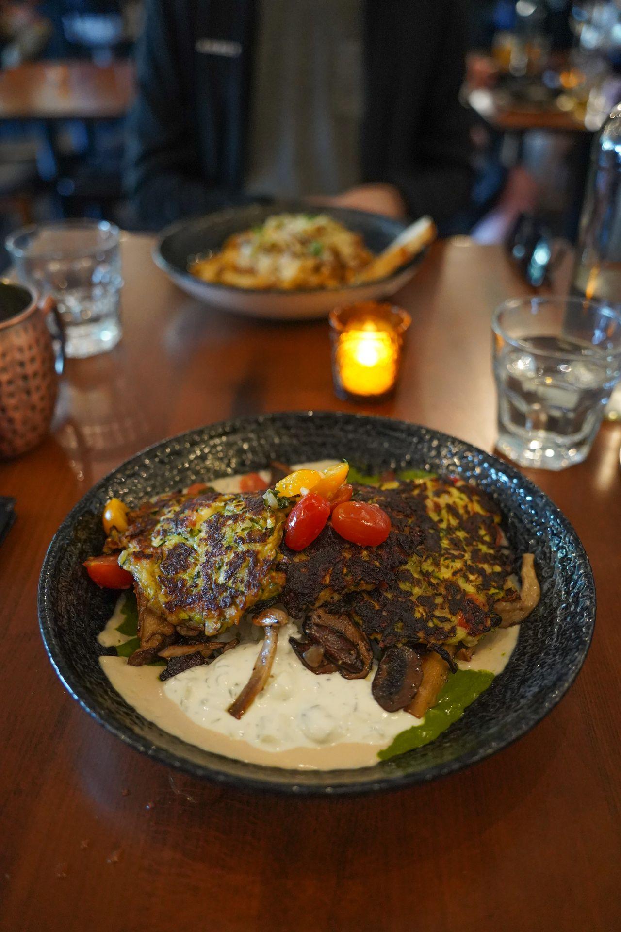 A plate with zucchini cakes, cherry tomatoes and sauce at the Bohemian Bar & Bistro