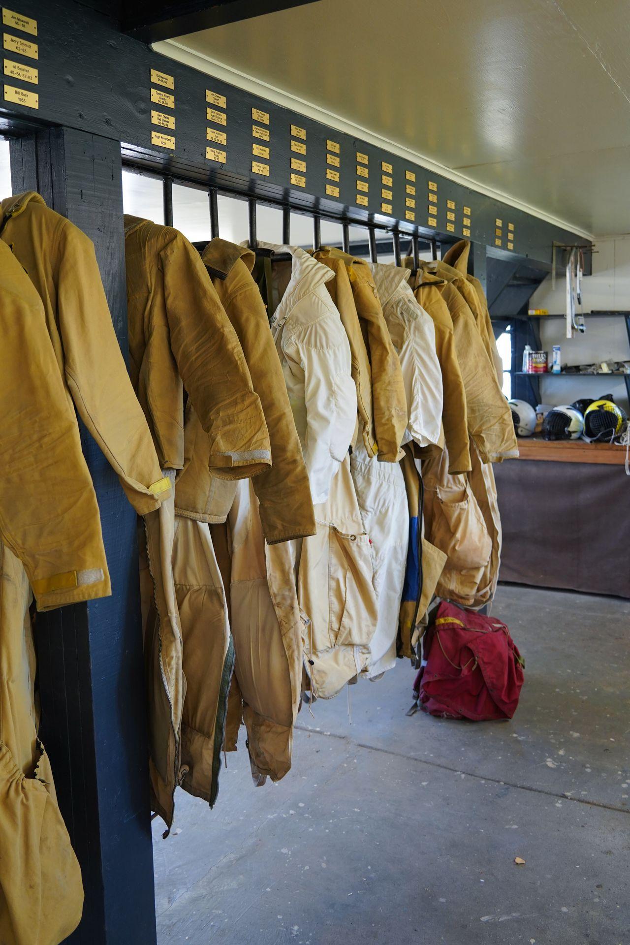 A rack full of yellow fire suits in the Siskiyou Smokejumper Museum