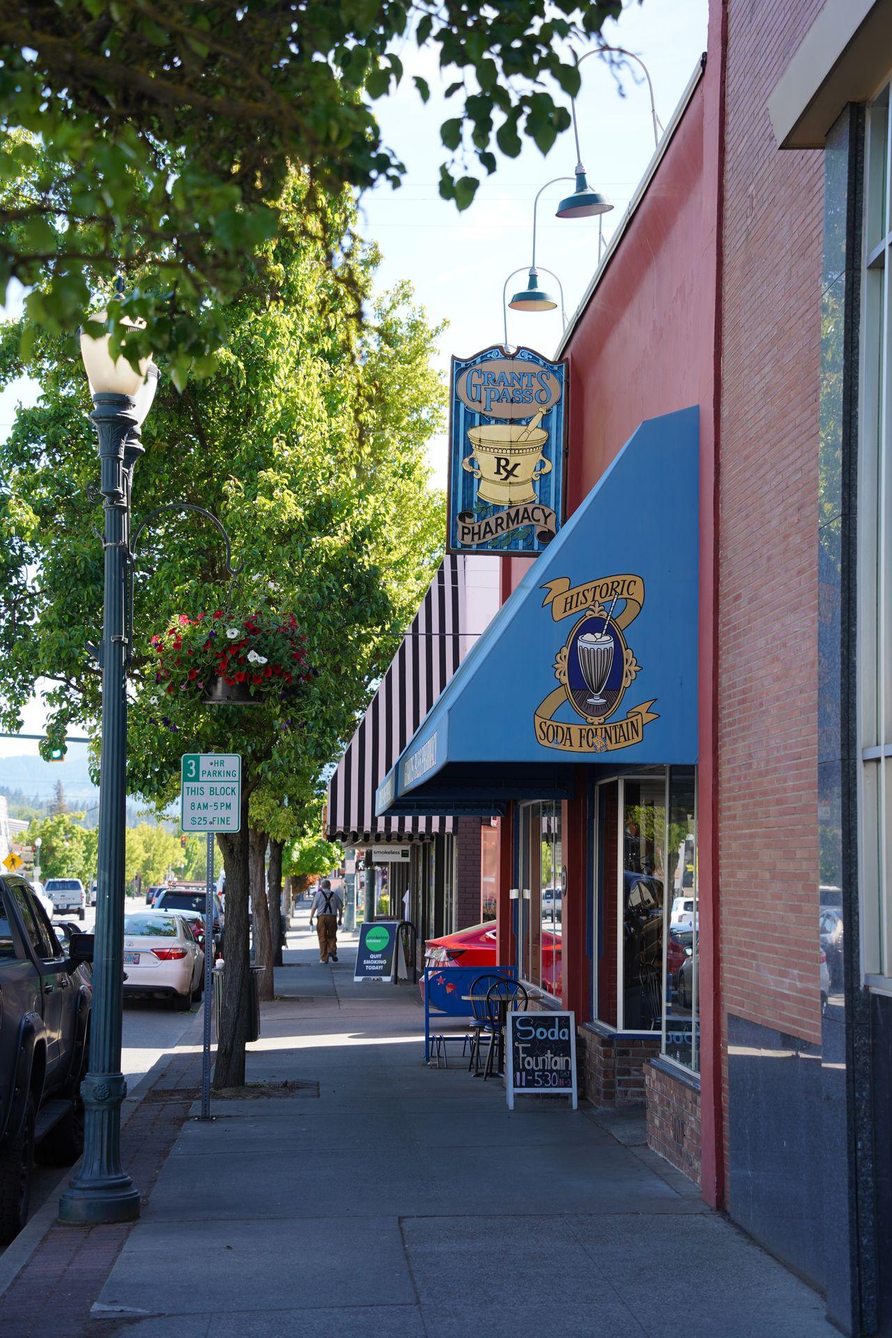 The exterior of Grants Pass Pharmacy. The awning reads 'Historic Soda Fountain'