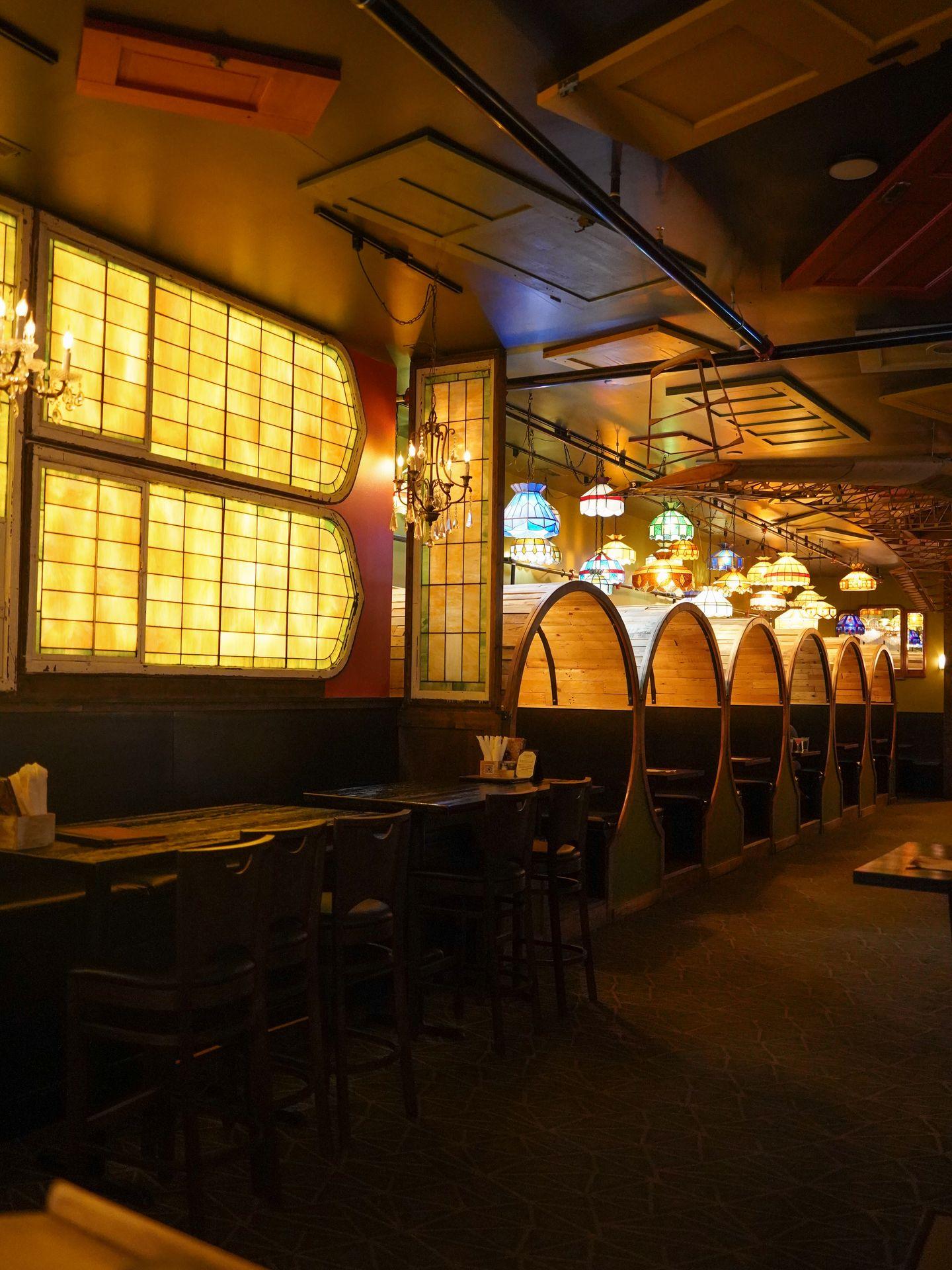 Round booths that look like barrels and stained glass windows at the hip-stir