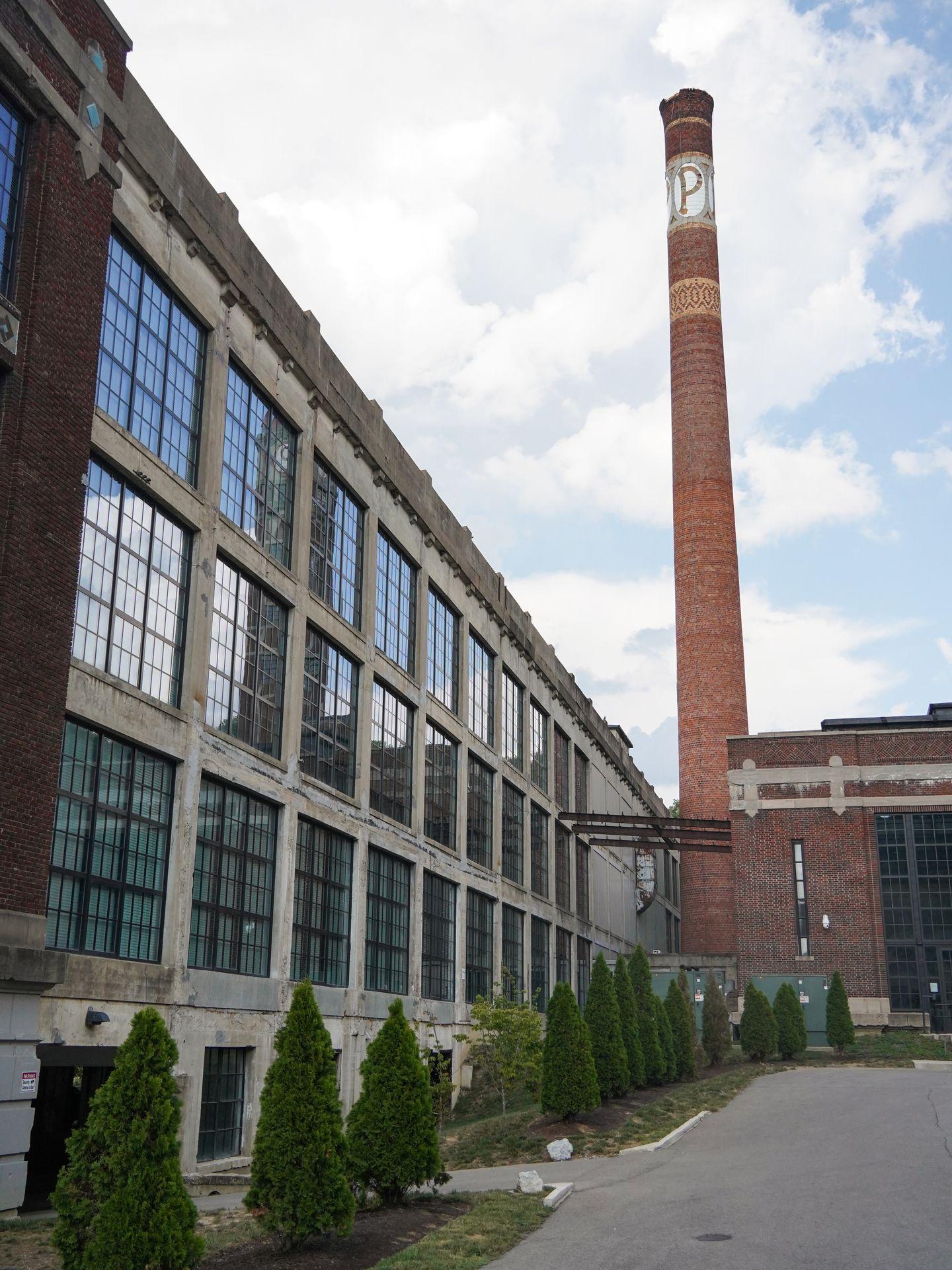 An industrial building with a tall smokestack