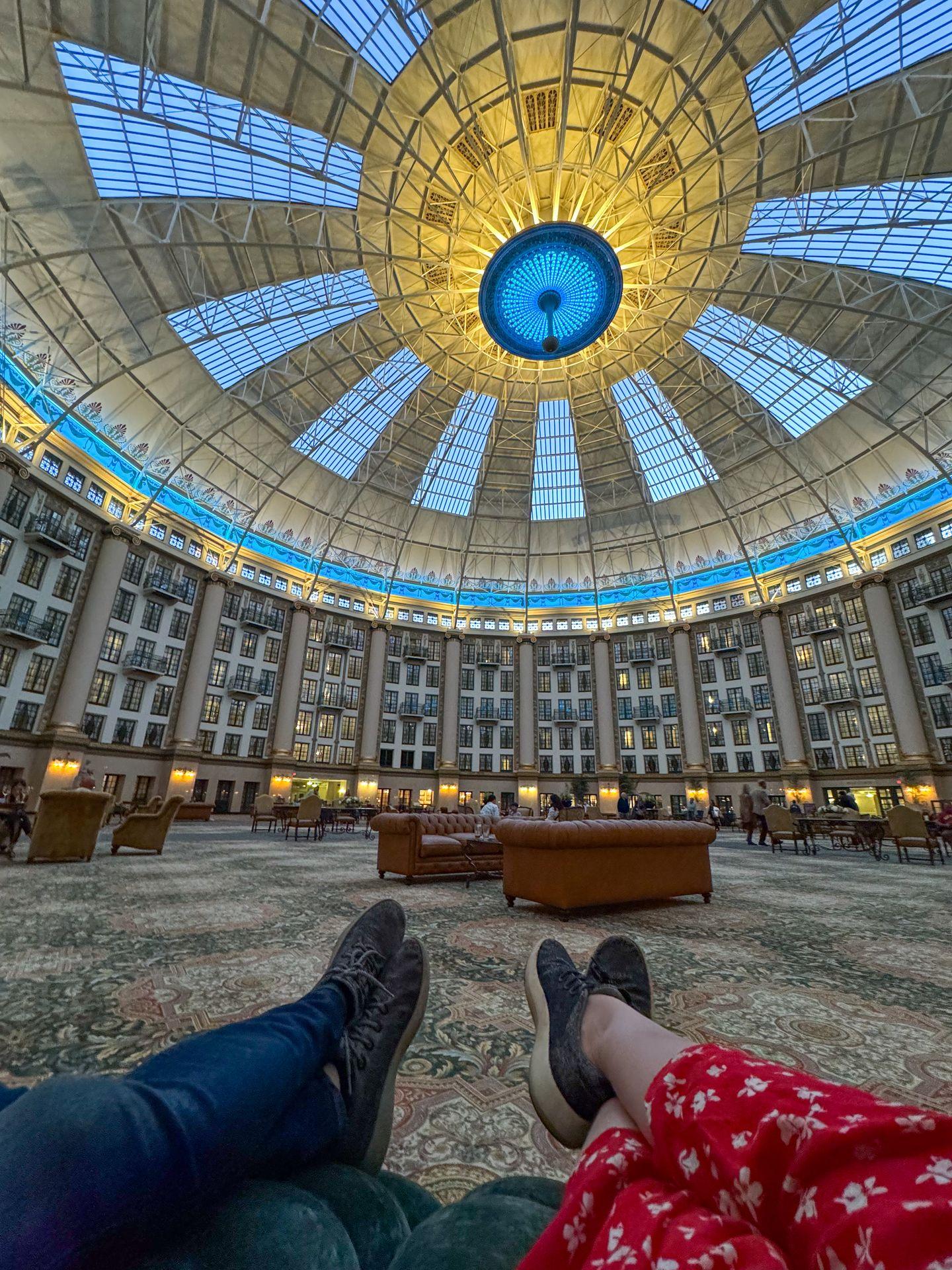 Looking out at two pairs of feet and the domed lobby at the West Baden Springs Hotel