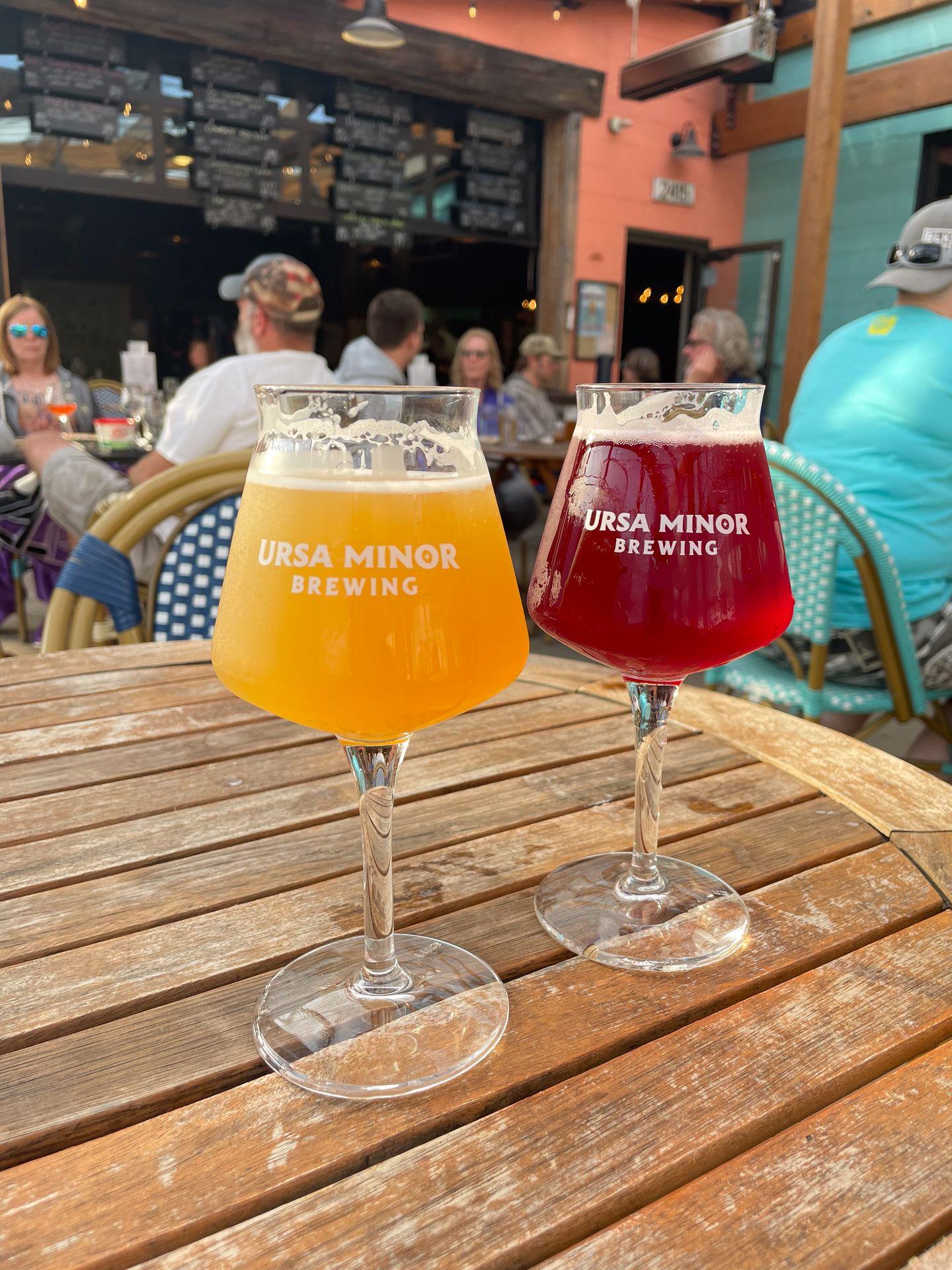 Two glasses of beer from Ursa Minor, one red and one orange.