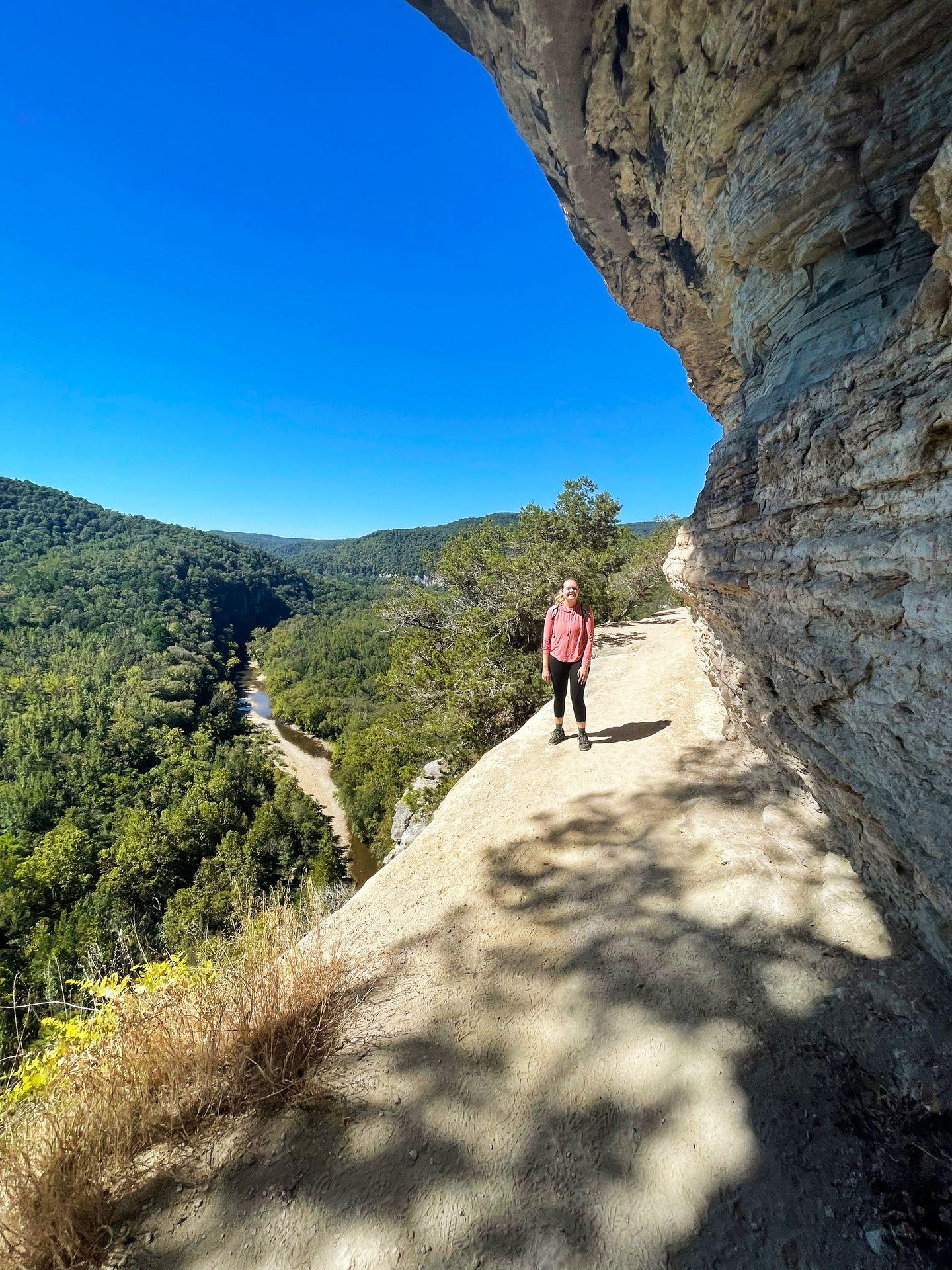 Lydia standing on Goat Bluff with a view of the Buffalo National River below to the left