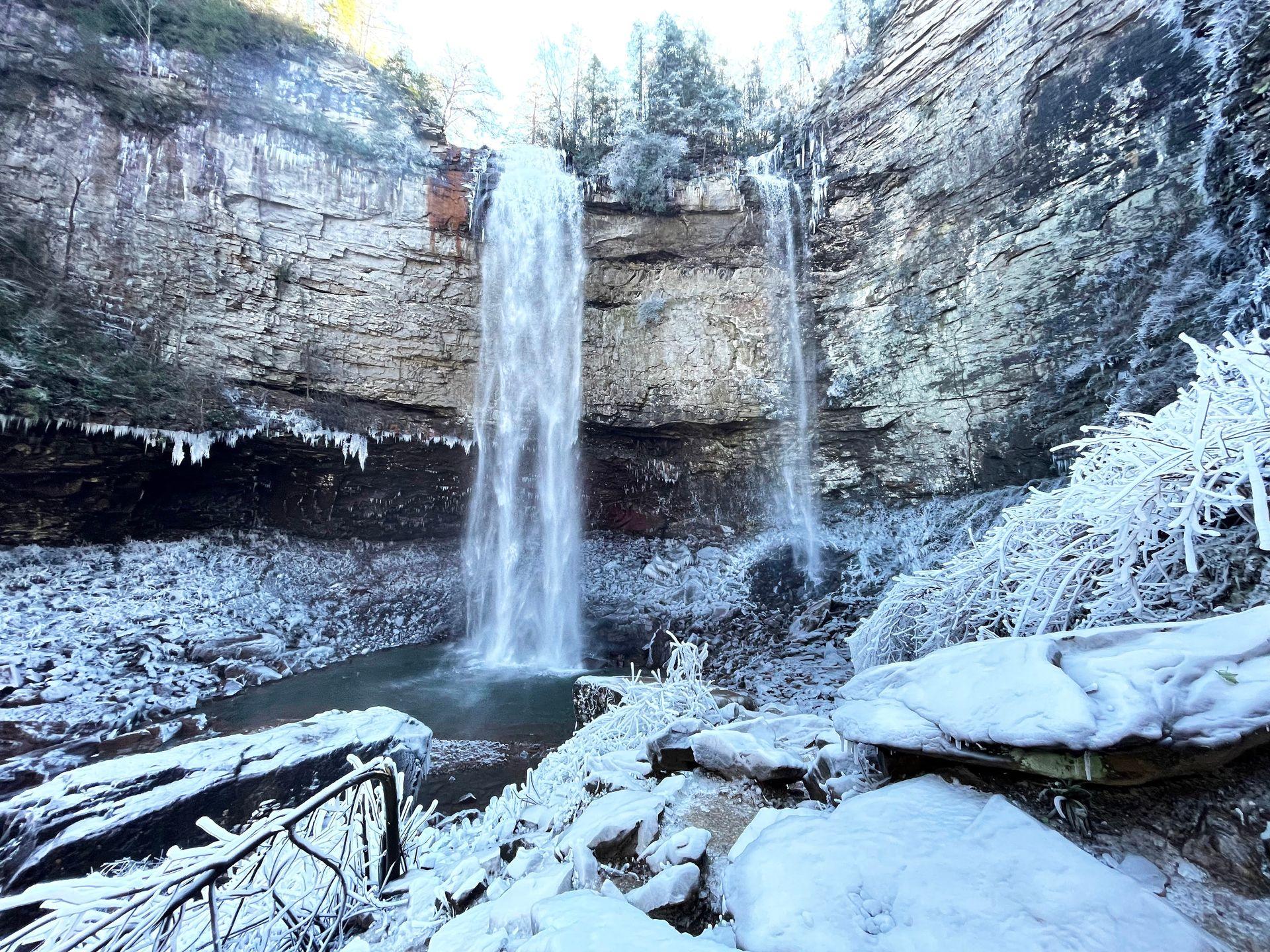 A waterfall surrounded by ice and snow at Fall Creek Falls State Park