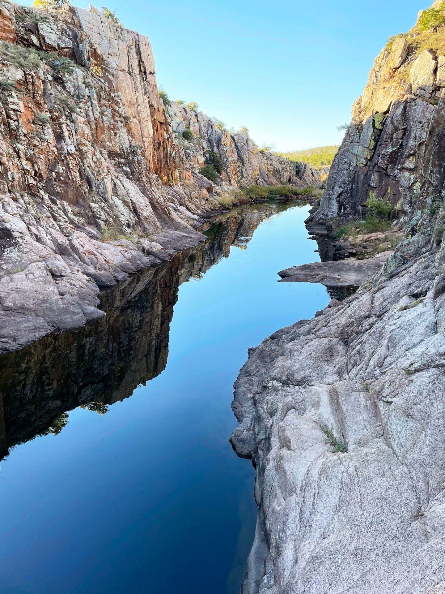 A river with rock walls towering up on both sides on the Forty Foot Hole trail.