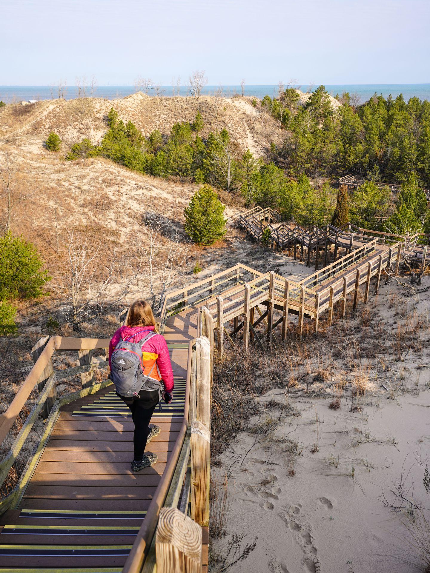 Lydia standing on a tower of wooden steps over sand dunes in Indiana Dunes National Park