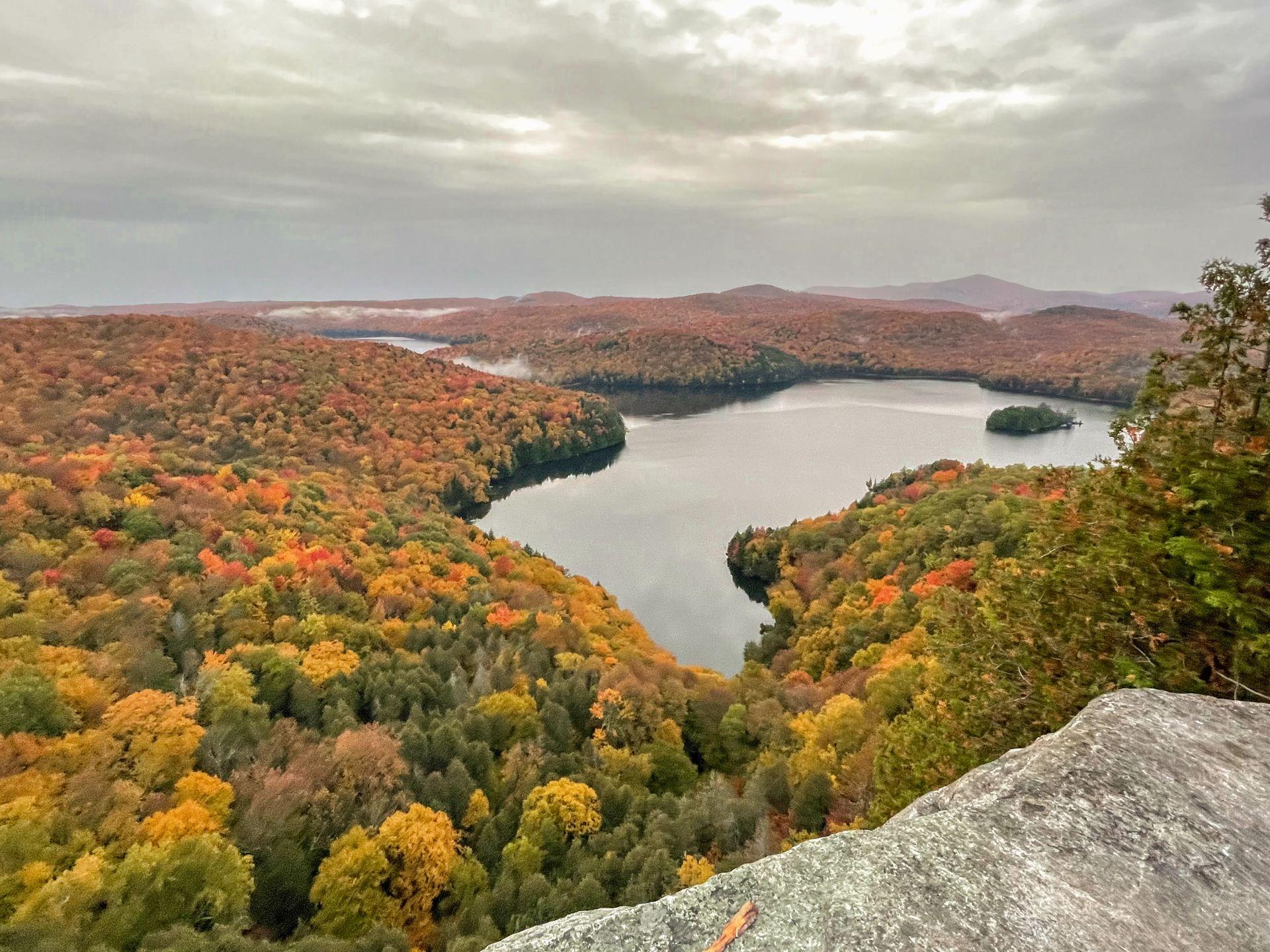 A view from above of a lake surrounded by colorful foliage.