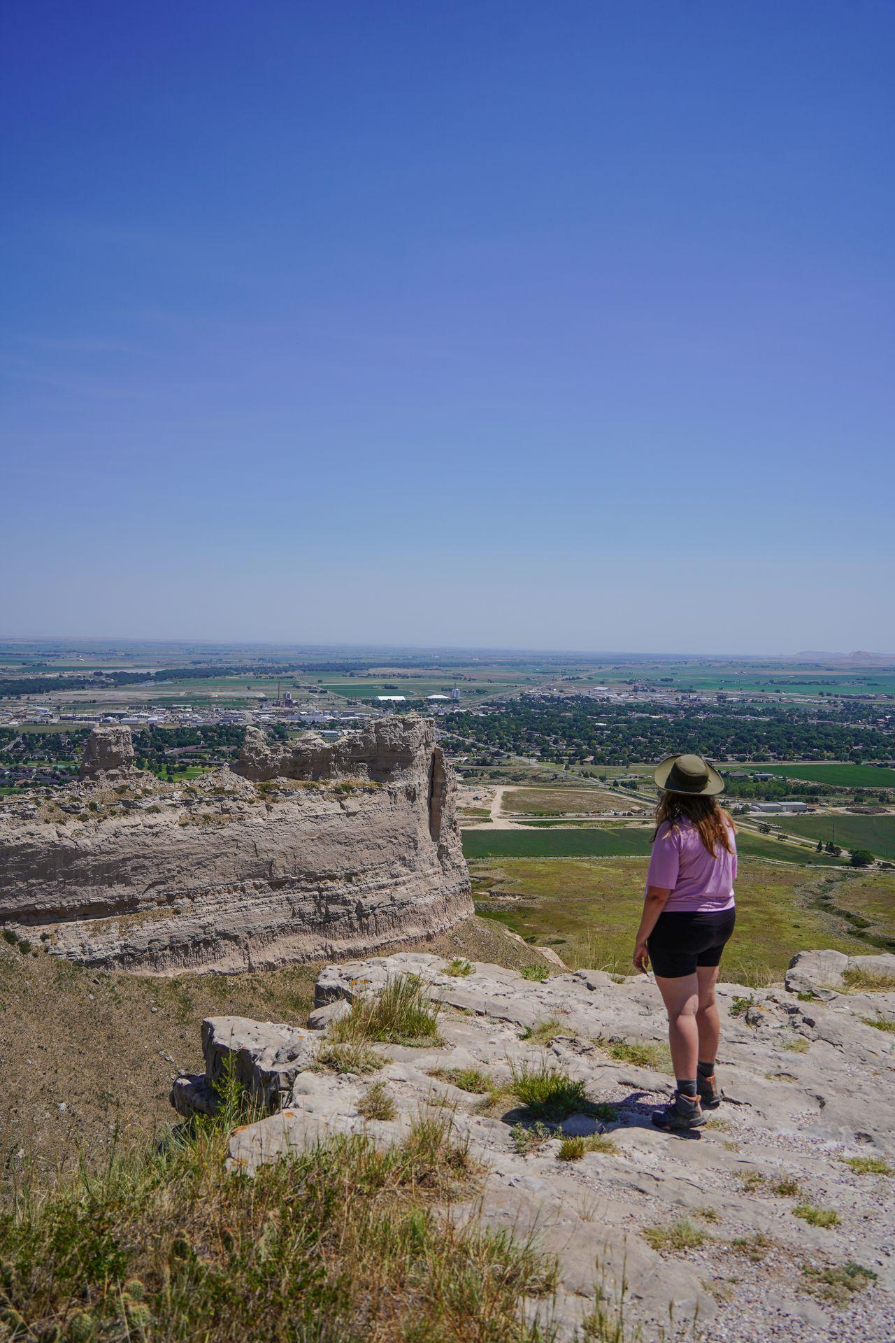 Lydia standing and looking out a view from the South Overlook in Scott's bluff National Monument