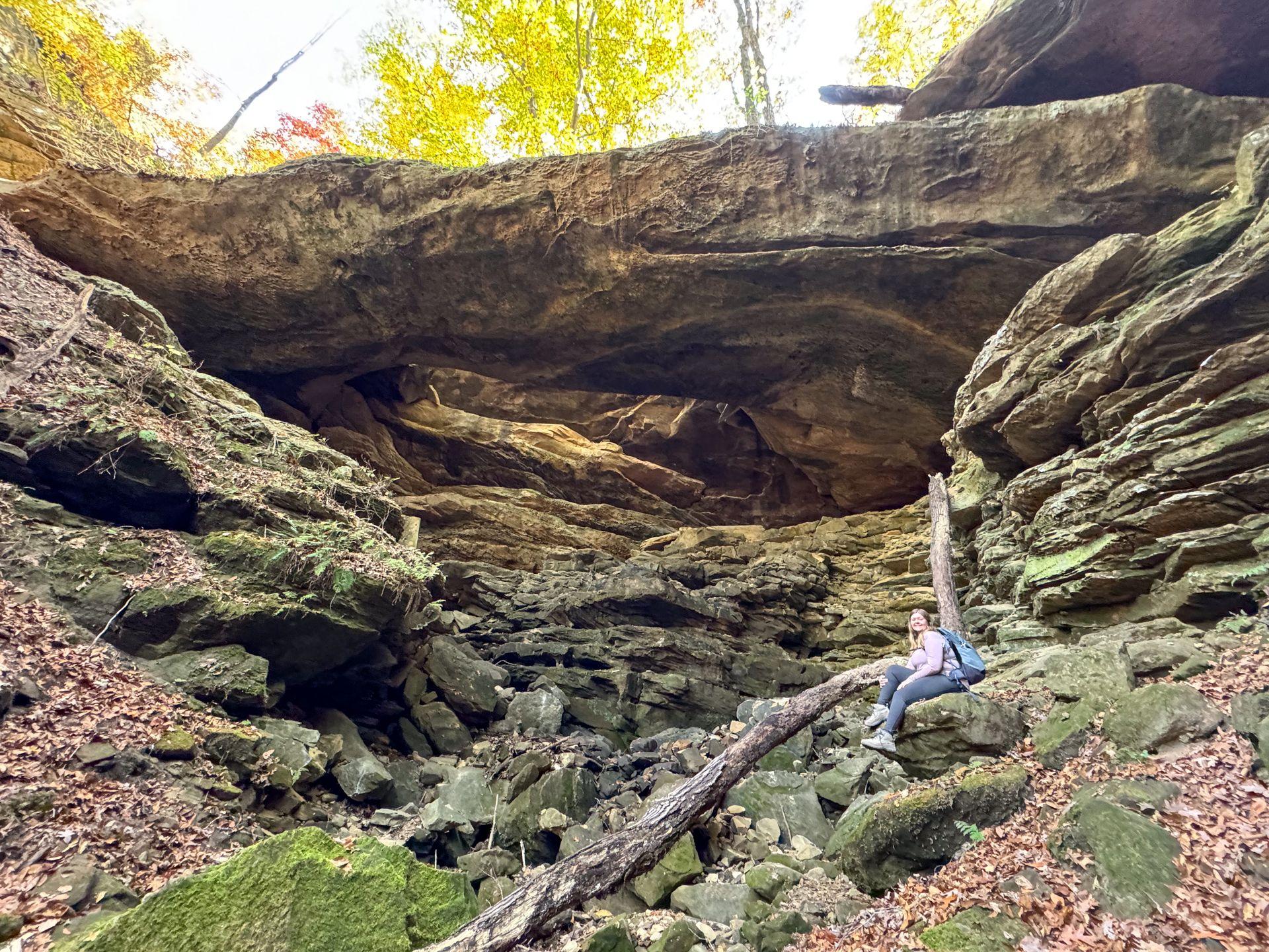 Lydia sitting below the natural bridge in Yellow Birch Ravine