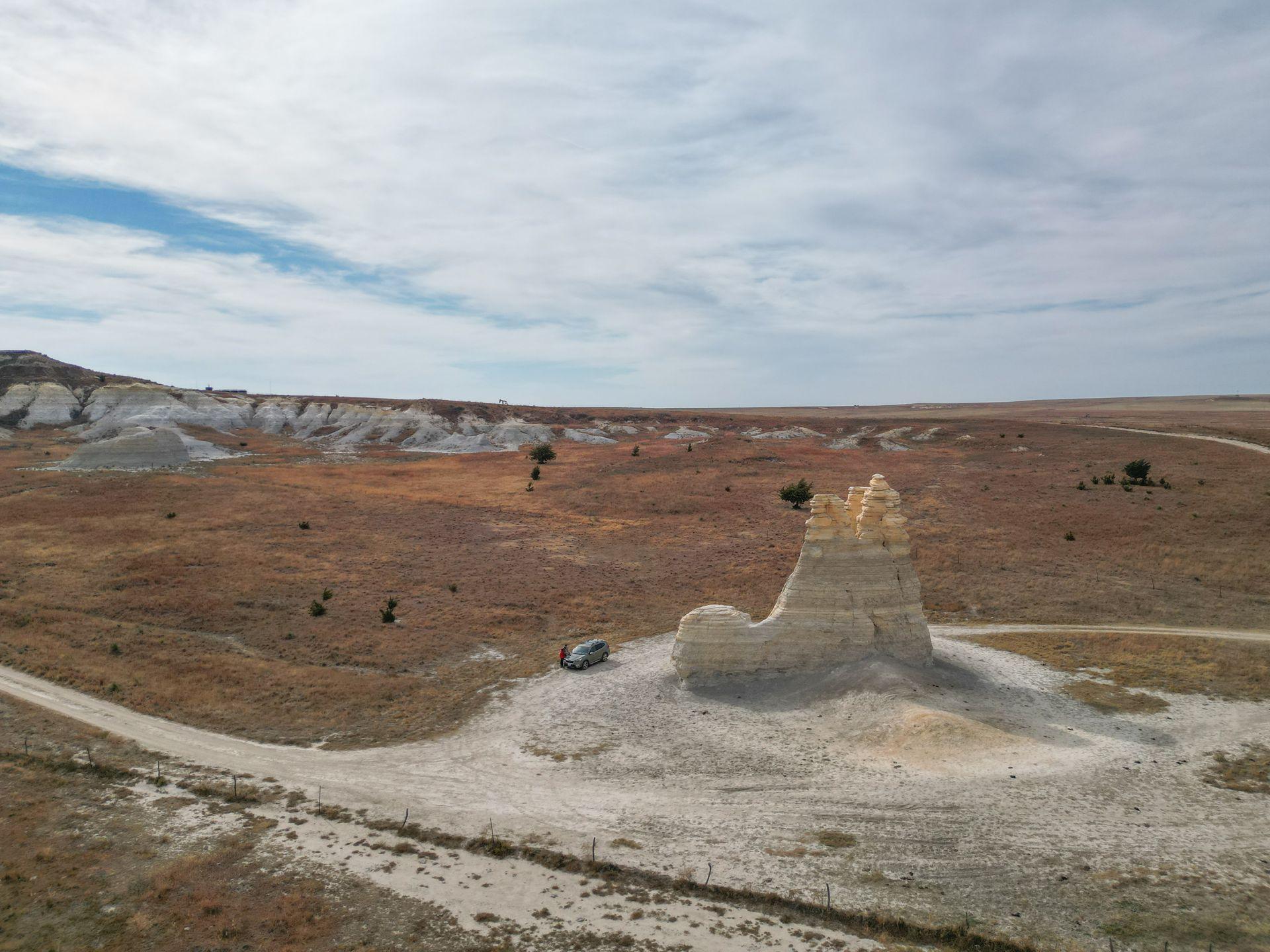 A drone photo of a chalk rock formation that resembles a castle