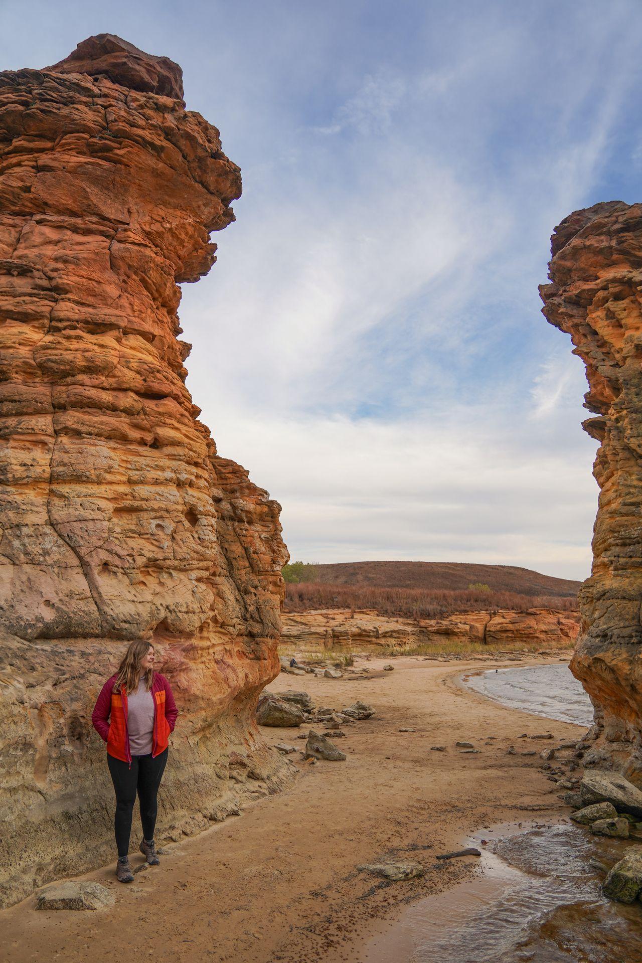 Lydia next to a giant rock pillar next to Wilson Lake