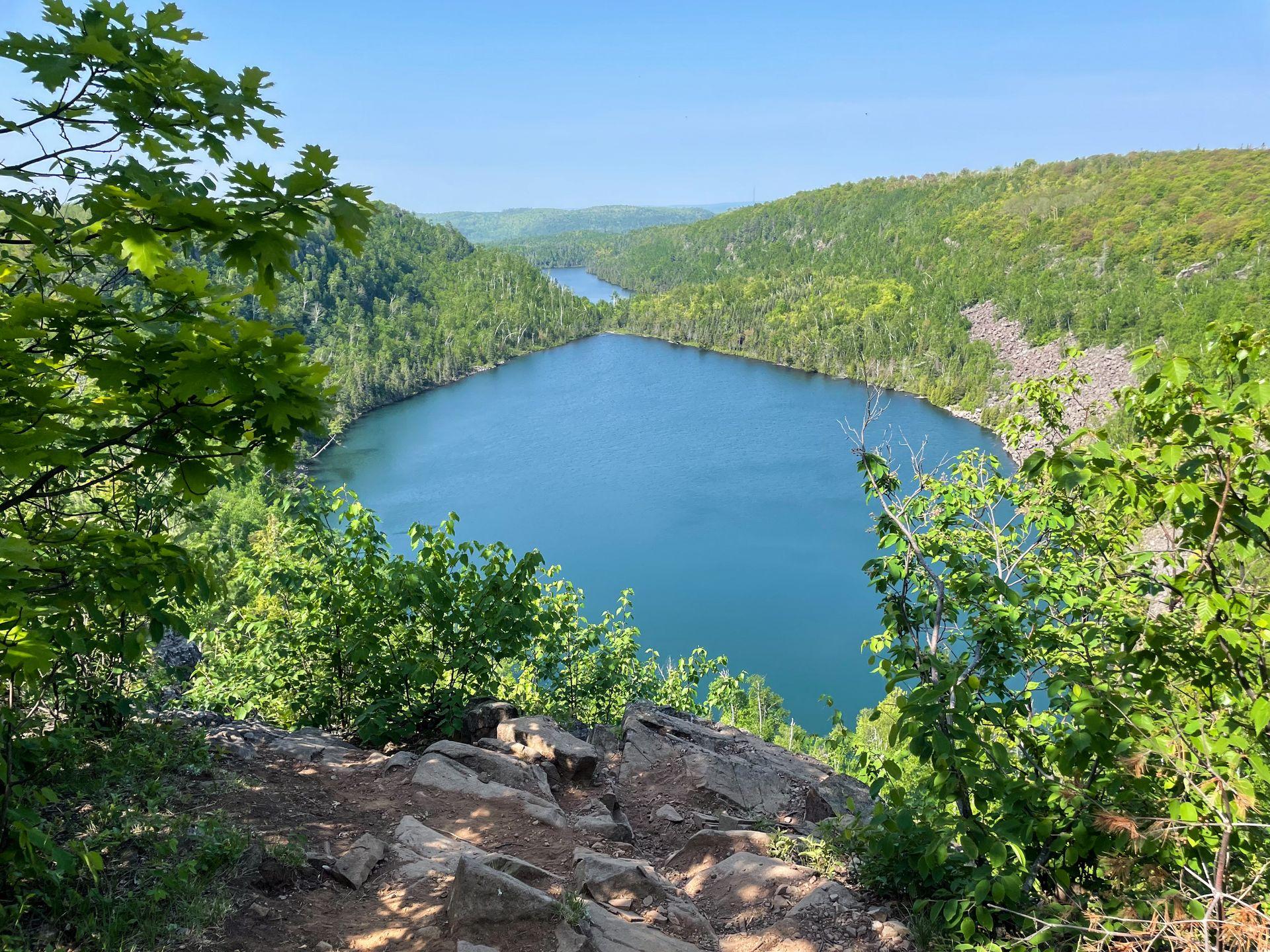 Looking straight out at both Bean and Bear Lake. The lakes are surrounded by green trees.