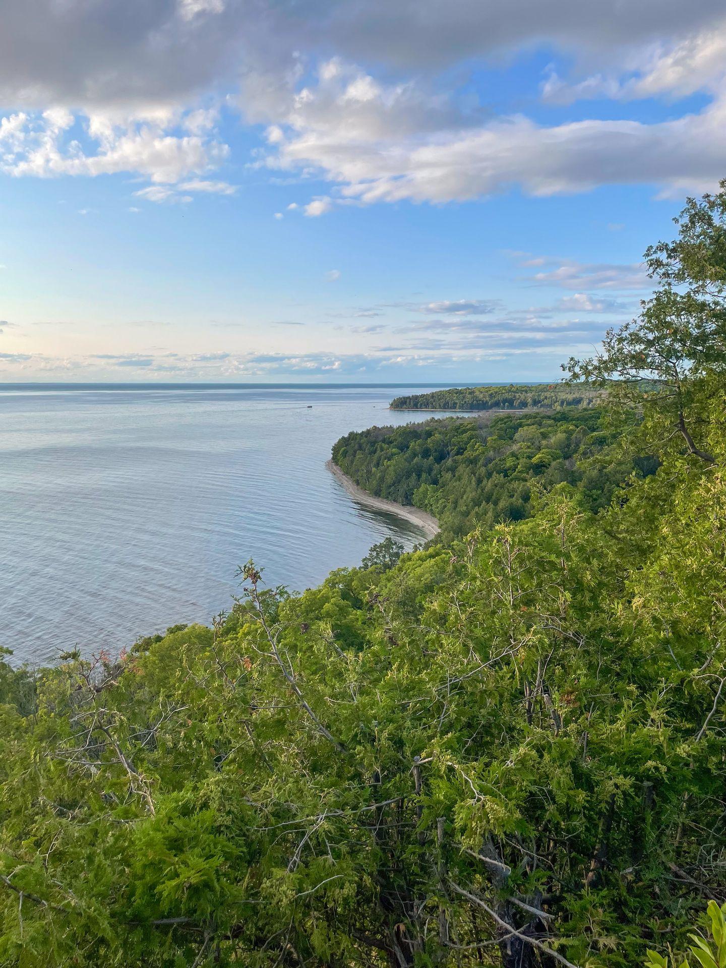 Looking down at a green coastline and blue water at Peninsula State Park