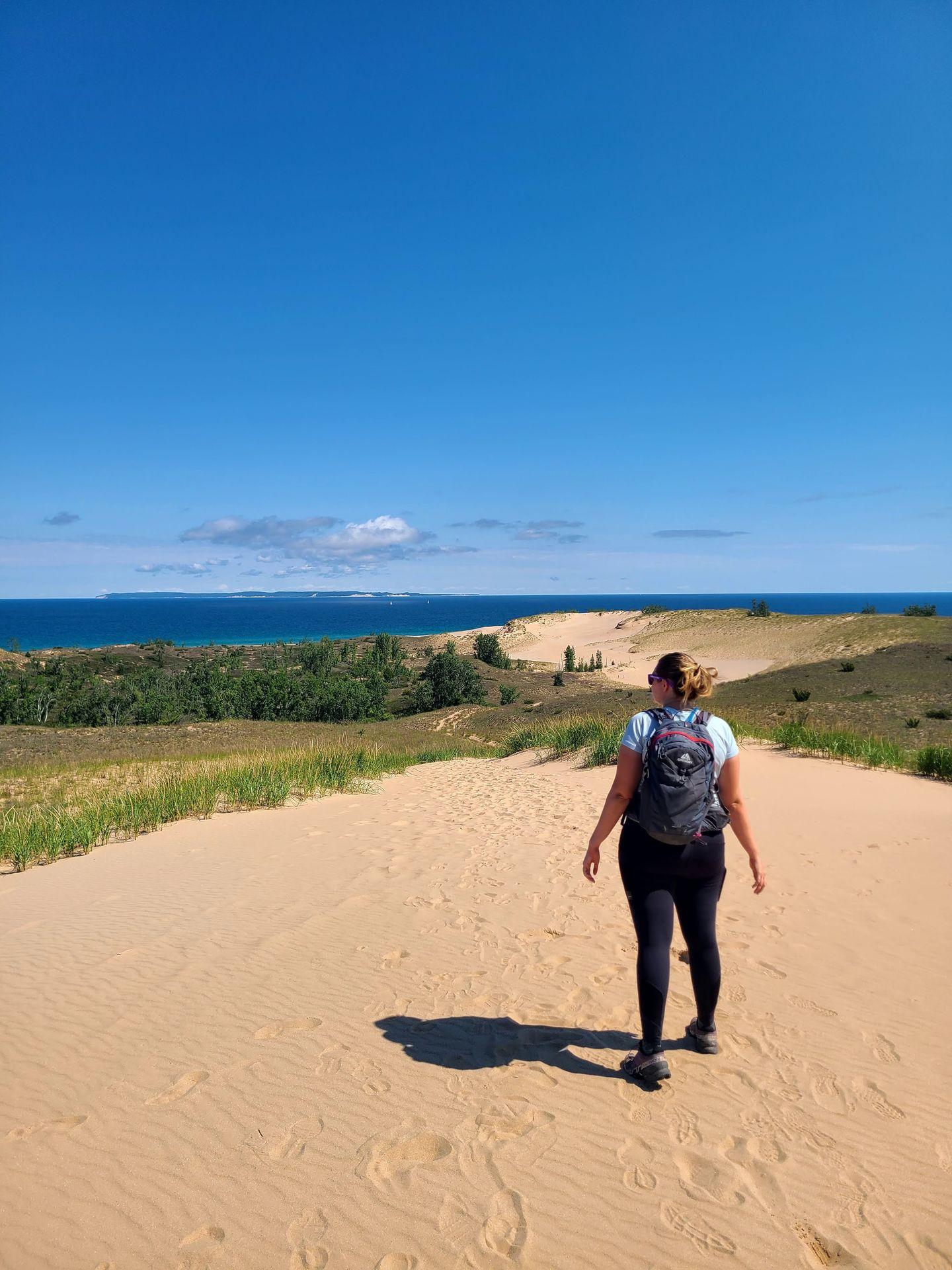 Lydia hiking on sand dunes at Sleeping Bear National Lakeshore