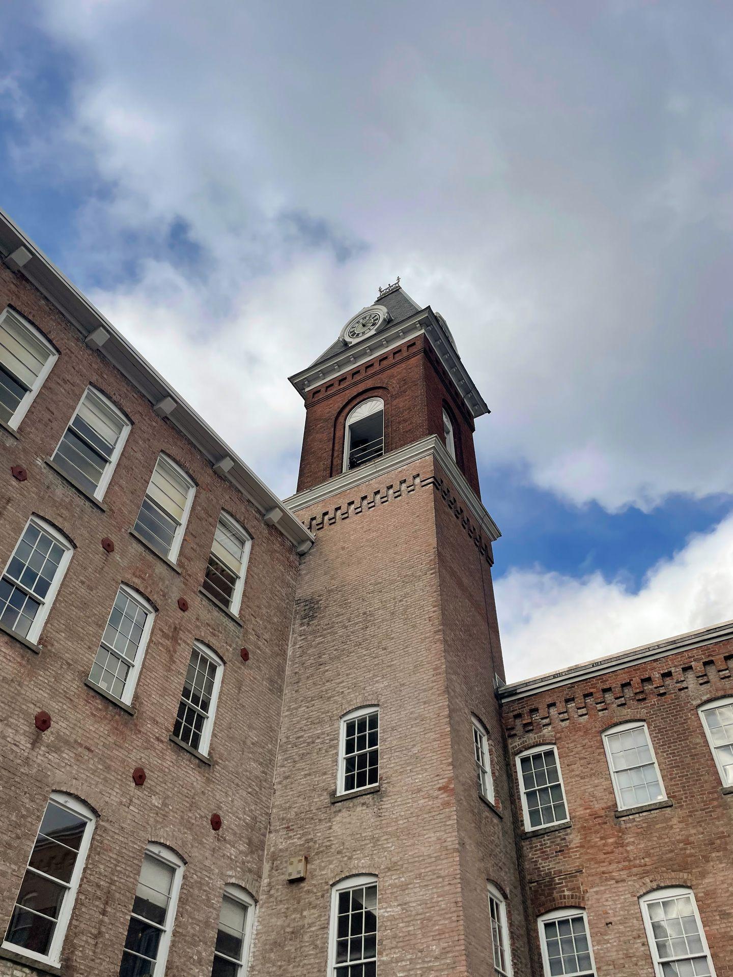 Looking up at a tower made of bricks at MASS MoCA