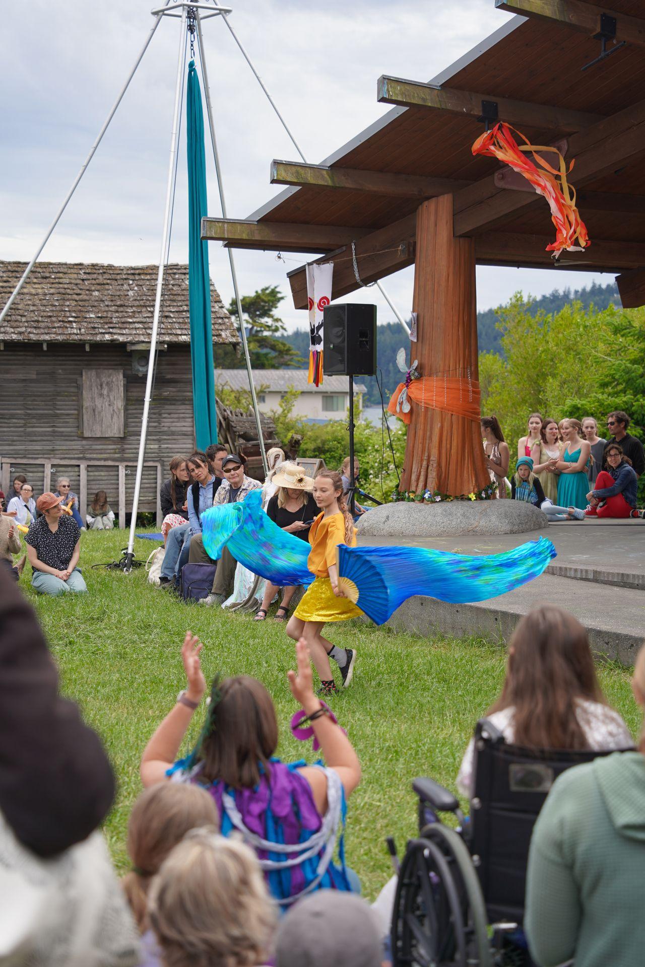 A girl dancing with ribbons at the Eastsound Farmer's Market