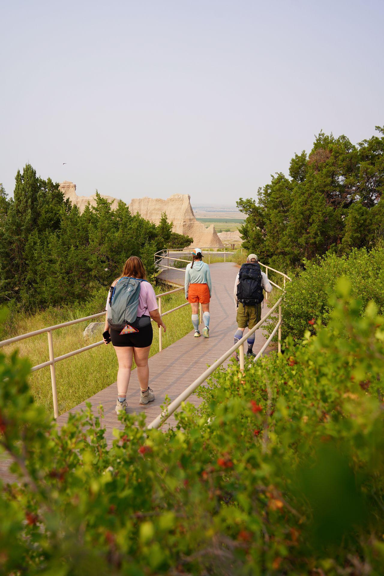 Lydia and friends hiking the Cliff Shelf Nature Trail, which is surrounded by greenery