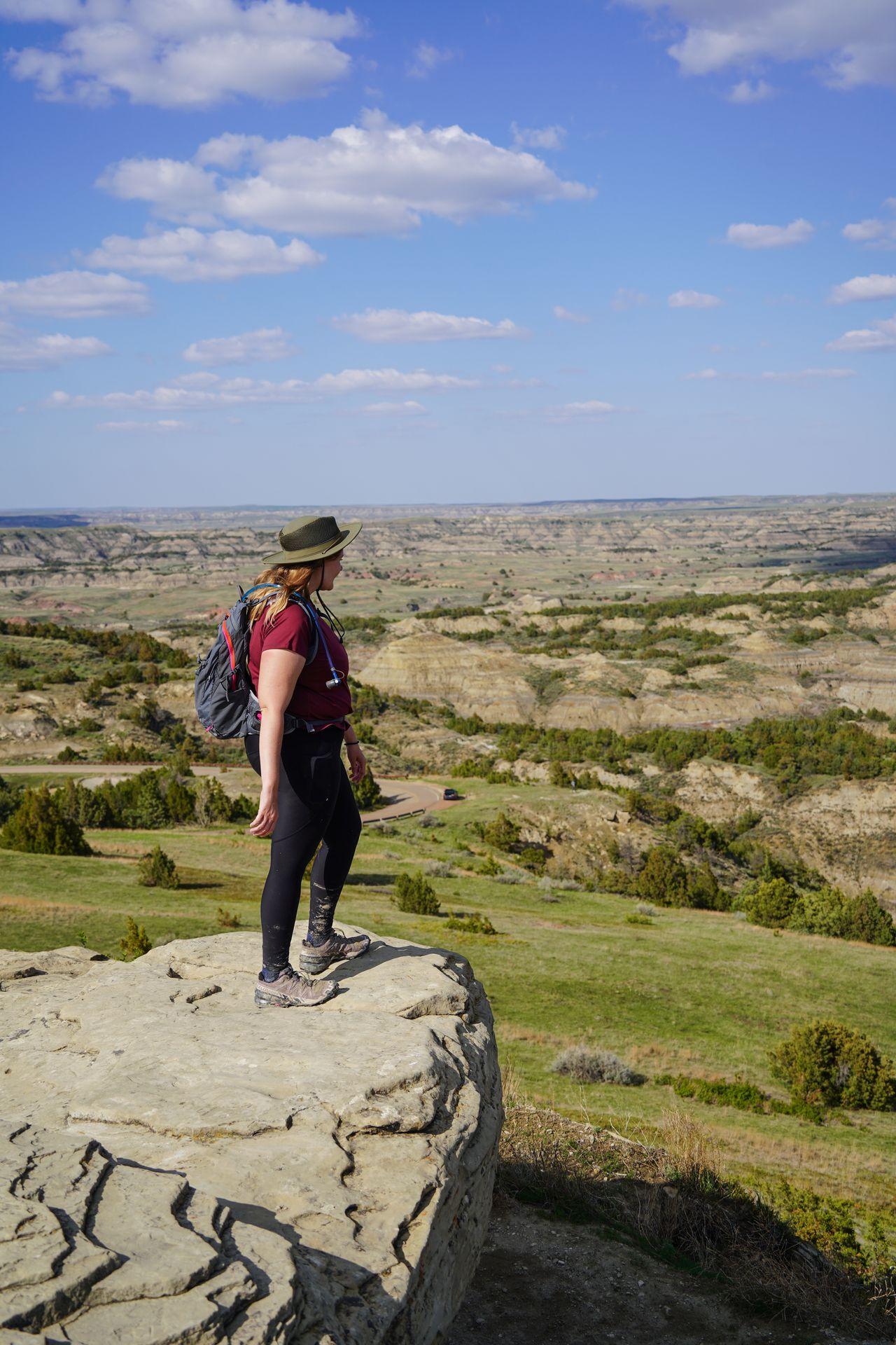 Lydia standing on a rock looking out at a valley on the Buck Hill Trail