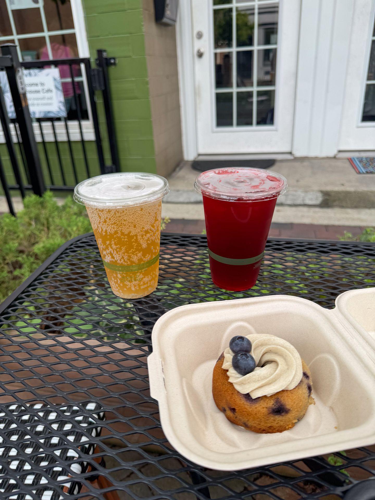 A blueberry donut and two iced beverages on the patio at Greenhouse Cafe