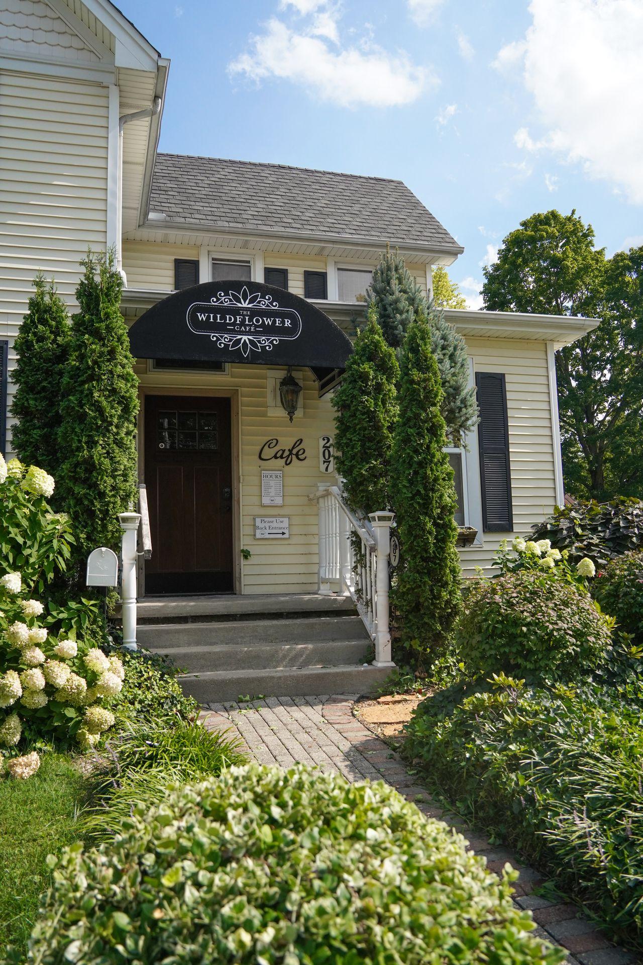 The exterior of Wildflower Cafe, which looks like a little house.