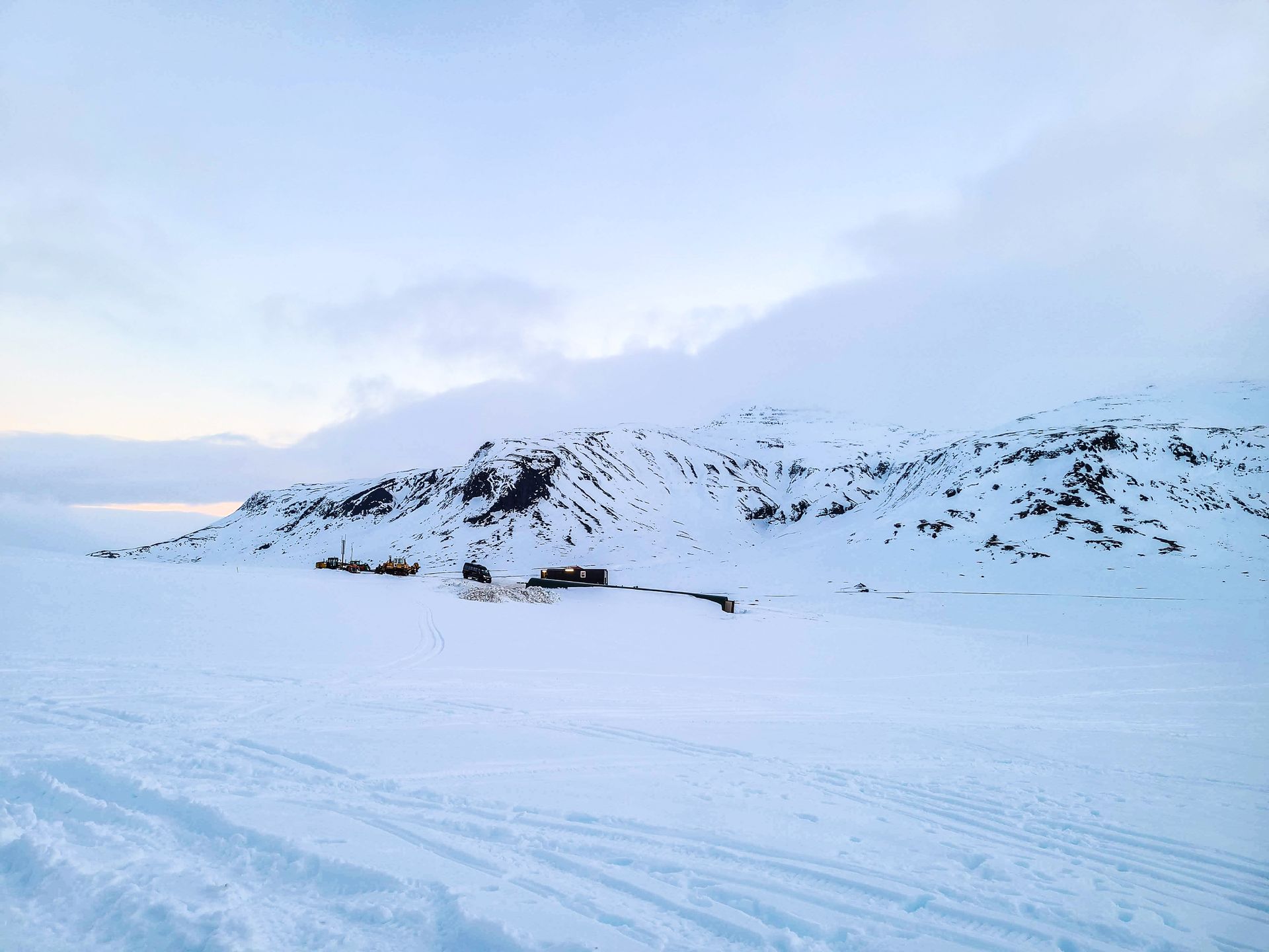 A snow covered glacier with a mountain in the background.