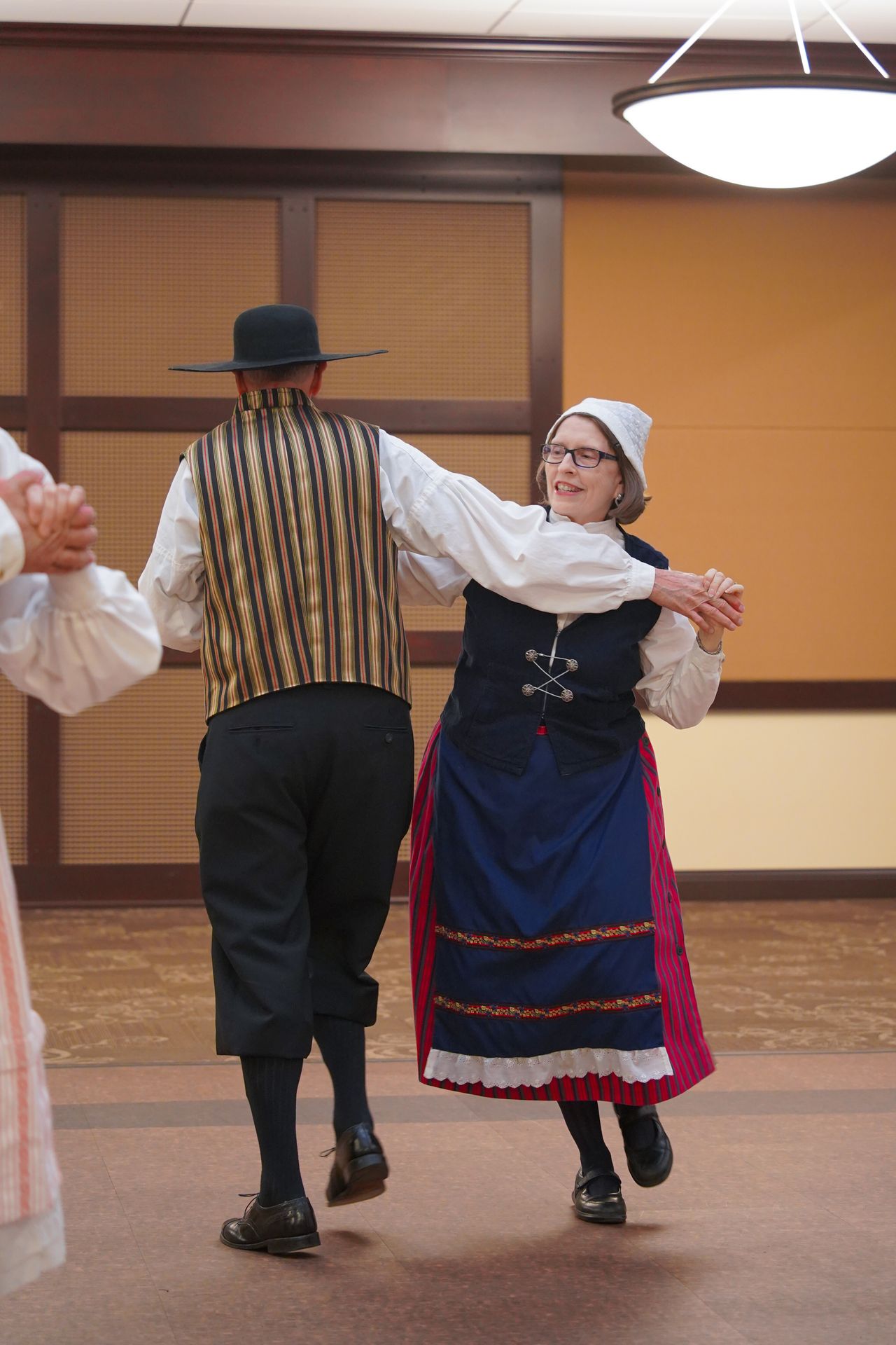 A couple part of the adult group of the Lindsborg Swedish Folk Dancers, dancing in traditonal Swedish clothes