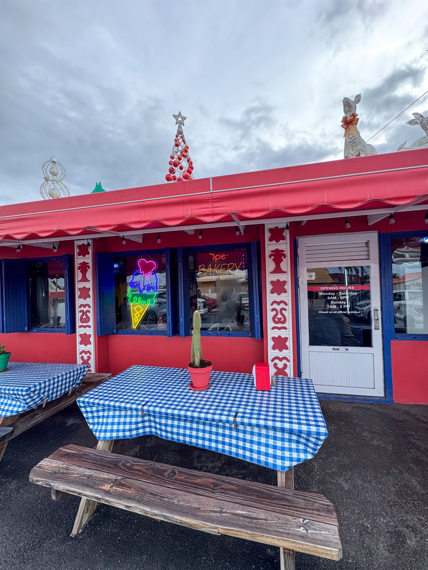 The exterior of Huchada, a red building with picnic tables out front