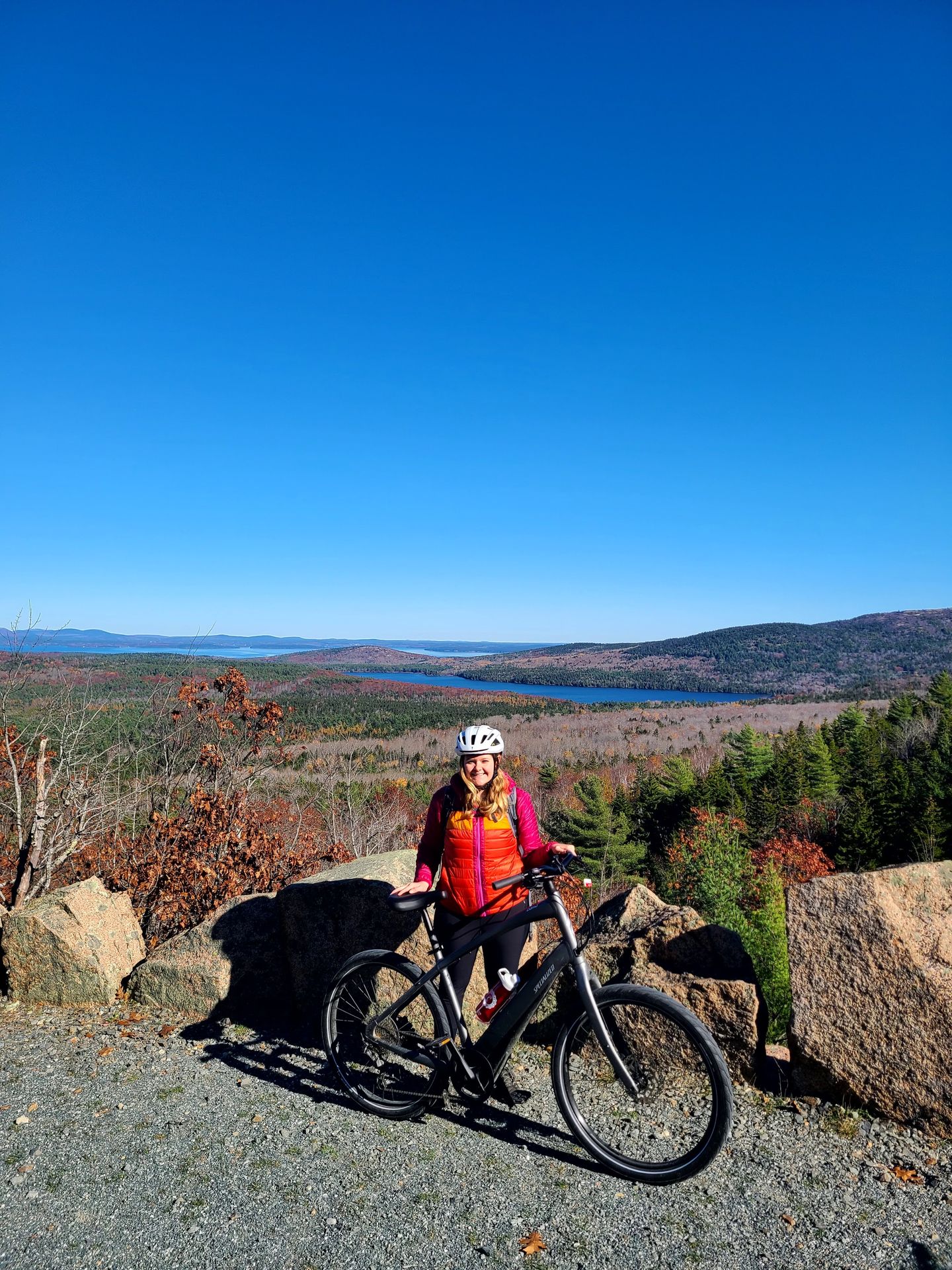 Lydia standing next to a bike on the Around the Mountain Loop.