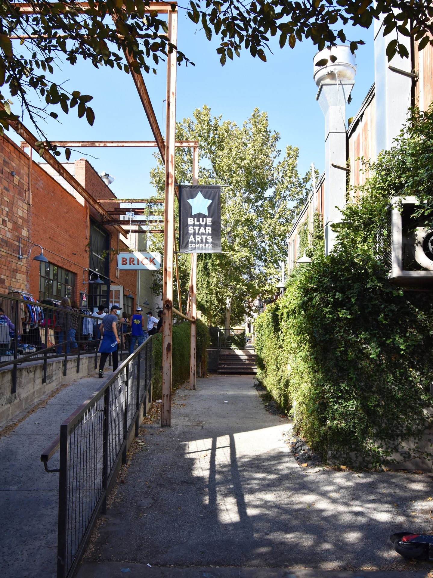 An outdoor area with a sign that reads 'Blue Star Arts Complex'