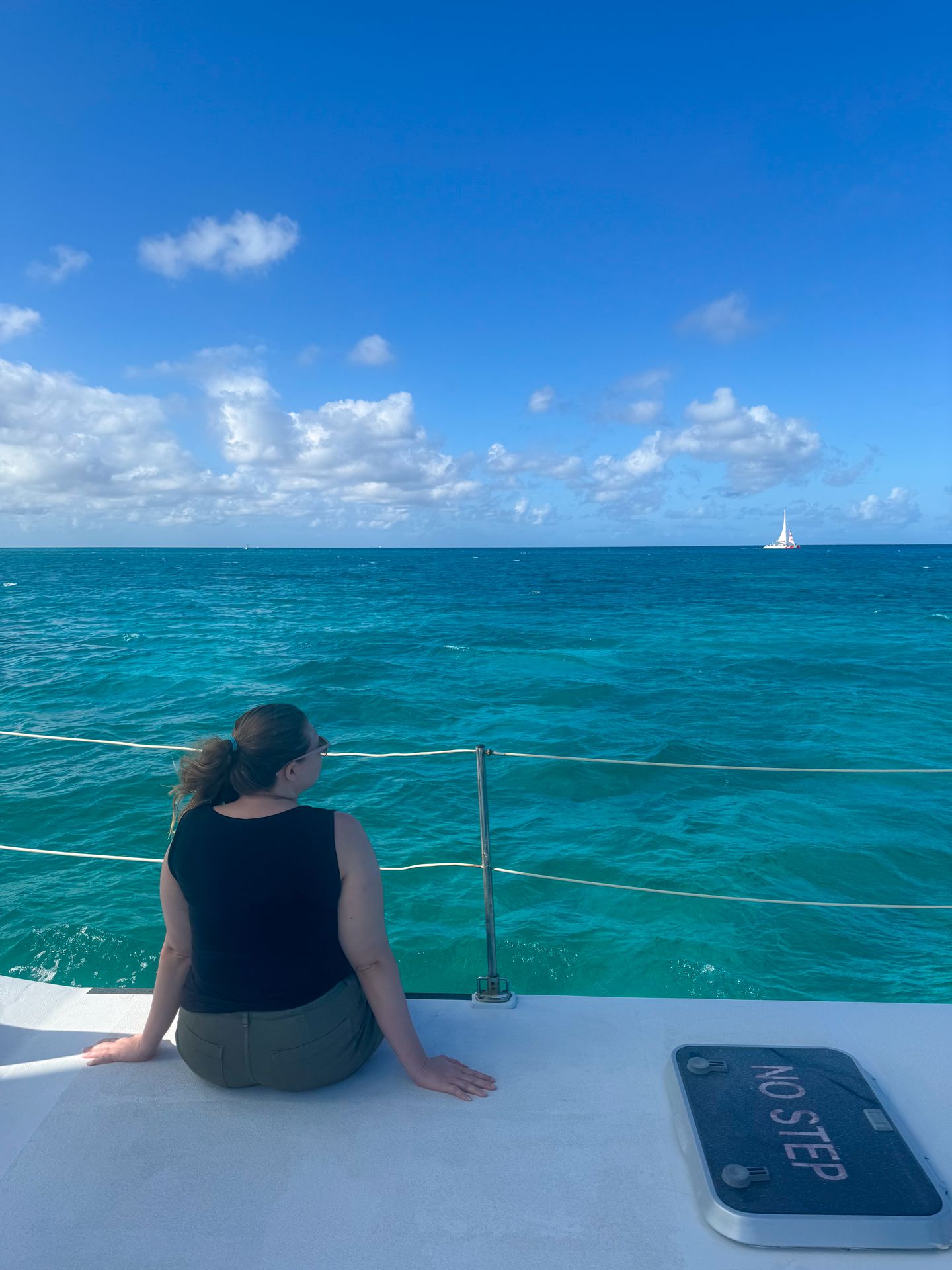 Lydia sitting on the edge of a boat