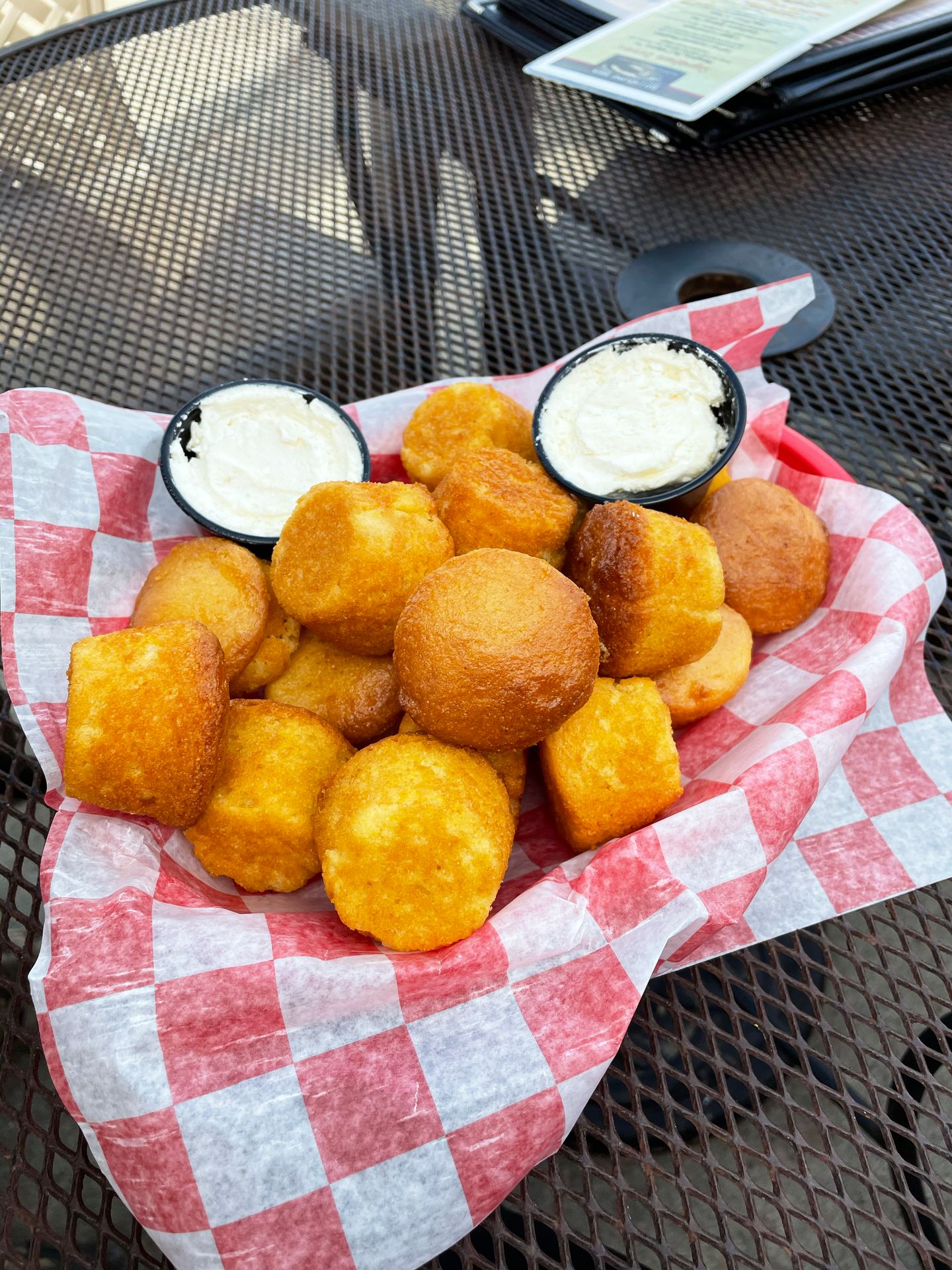 A basket of small cornbread muffins from Millstone BBQ