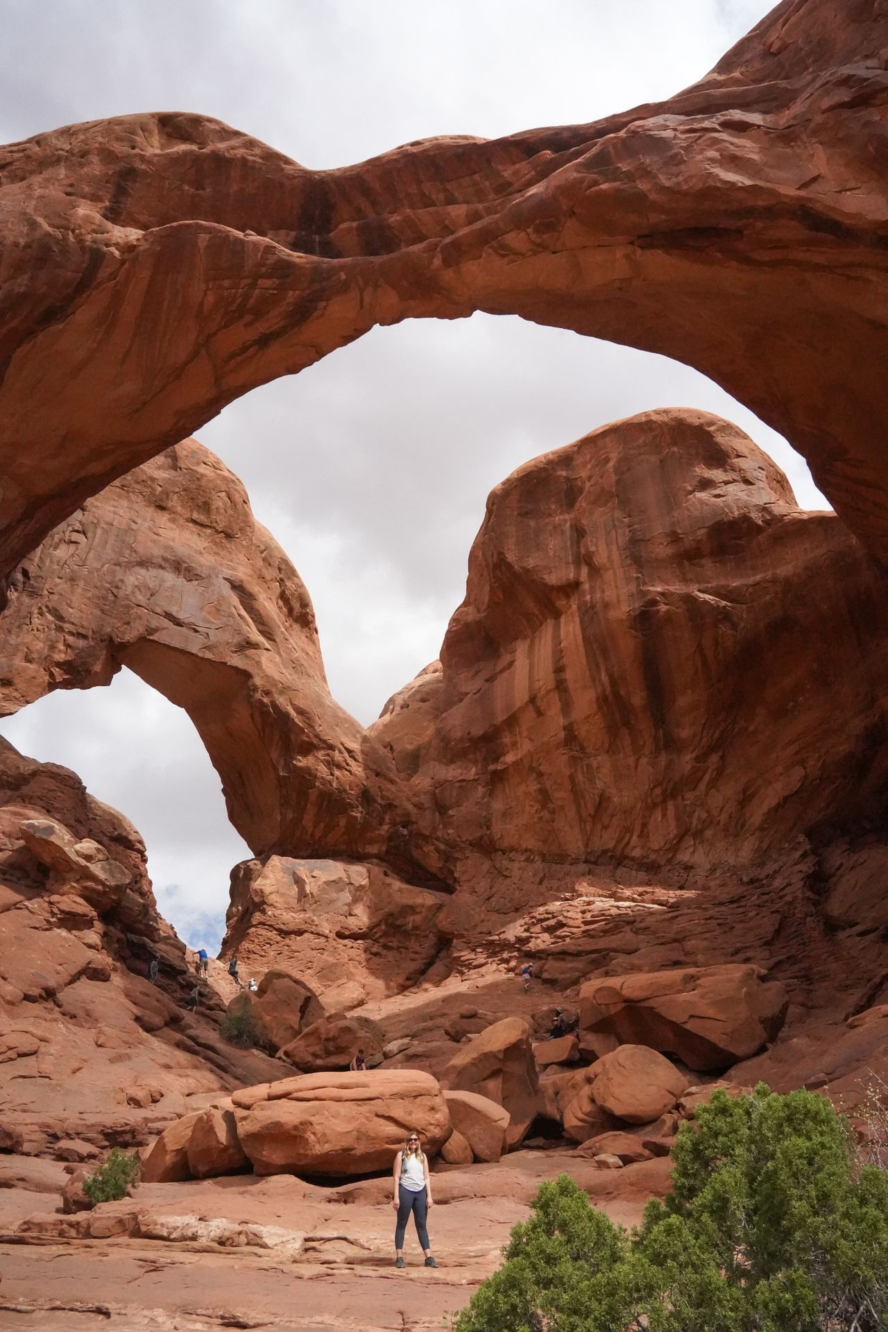 Lydia standing at the bottom of 2 massive arches