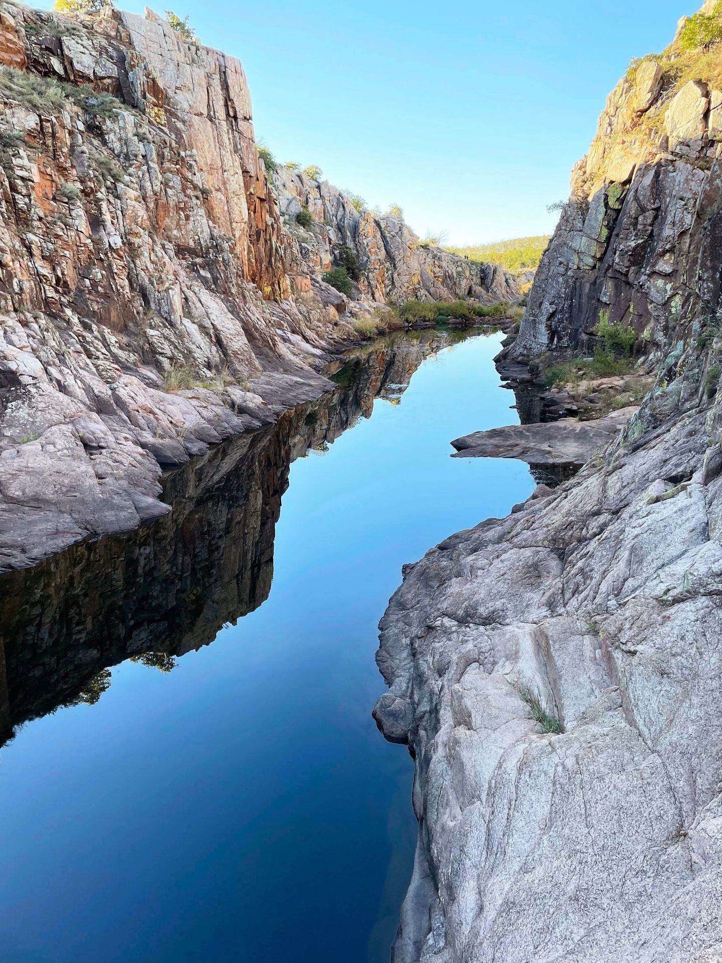 A river with rock walls towering up on both sides on the Forty Foot Hole trail.