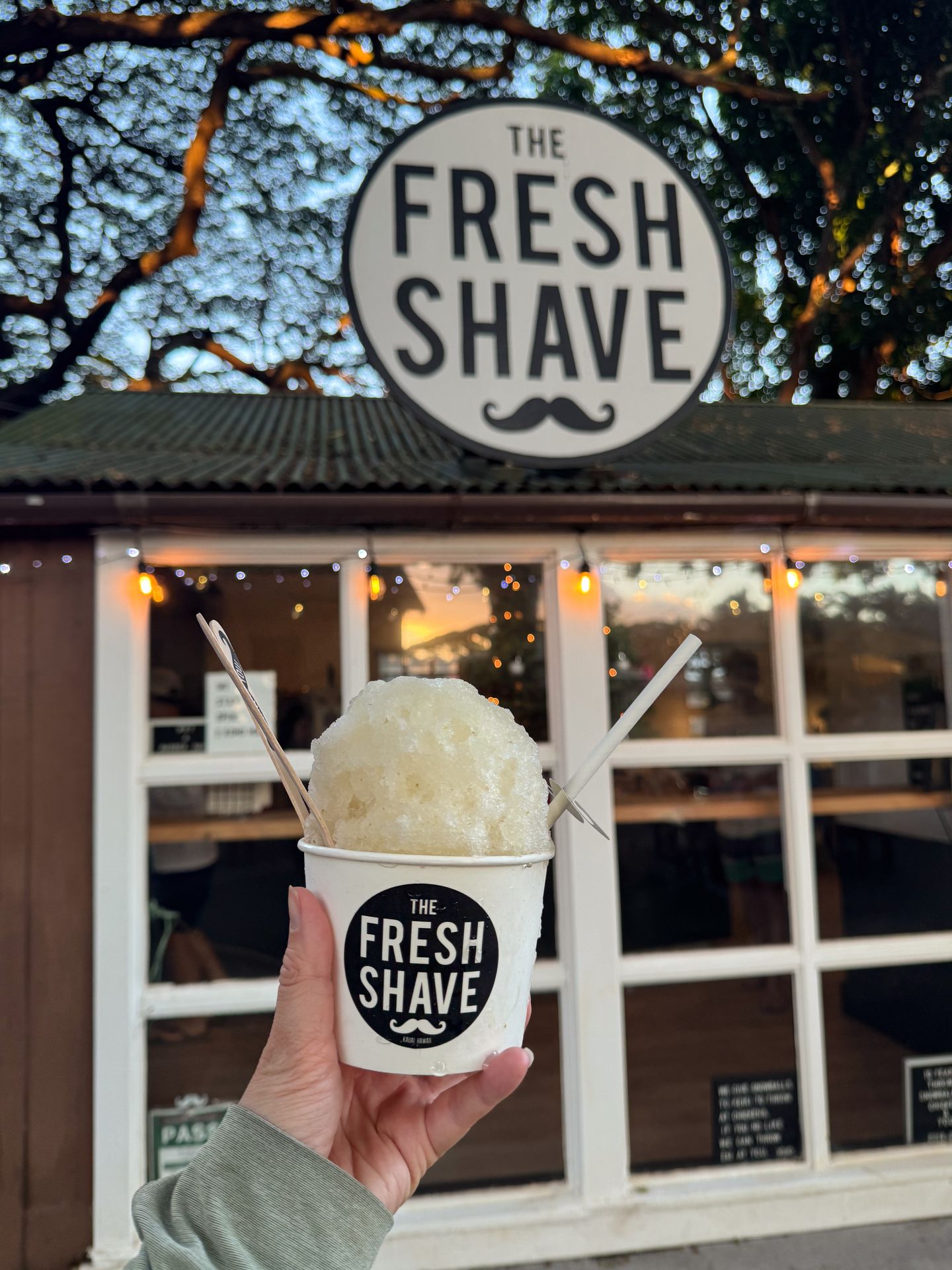 Holding up shave ice outside of The Fresh Shave