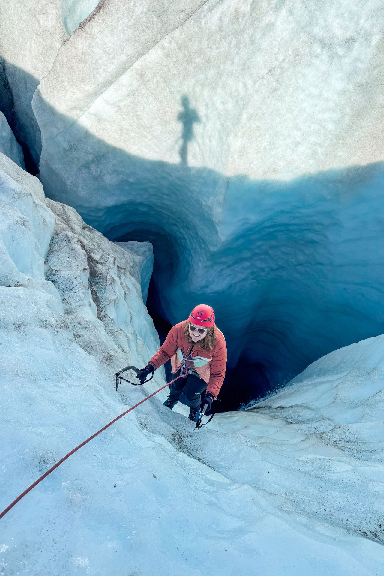 Lydia ice climbing in a glacier moulin in Wrangell-St. Elias