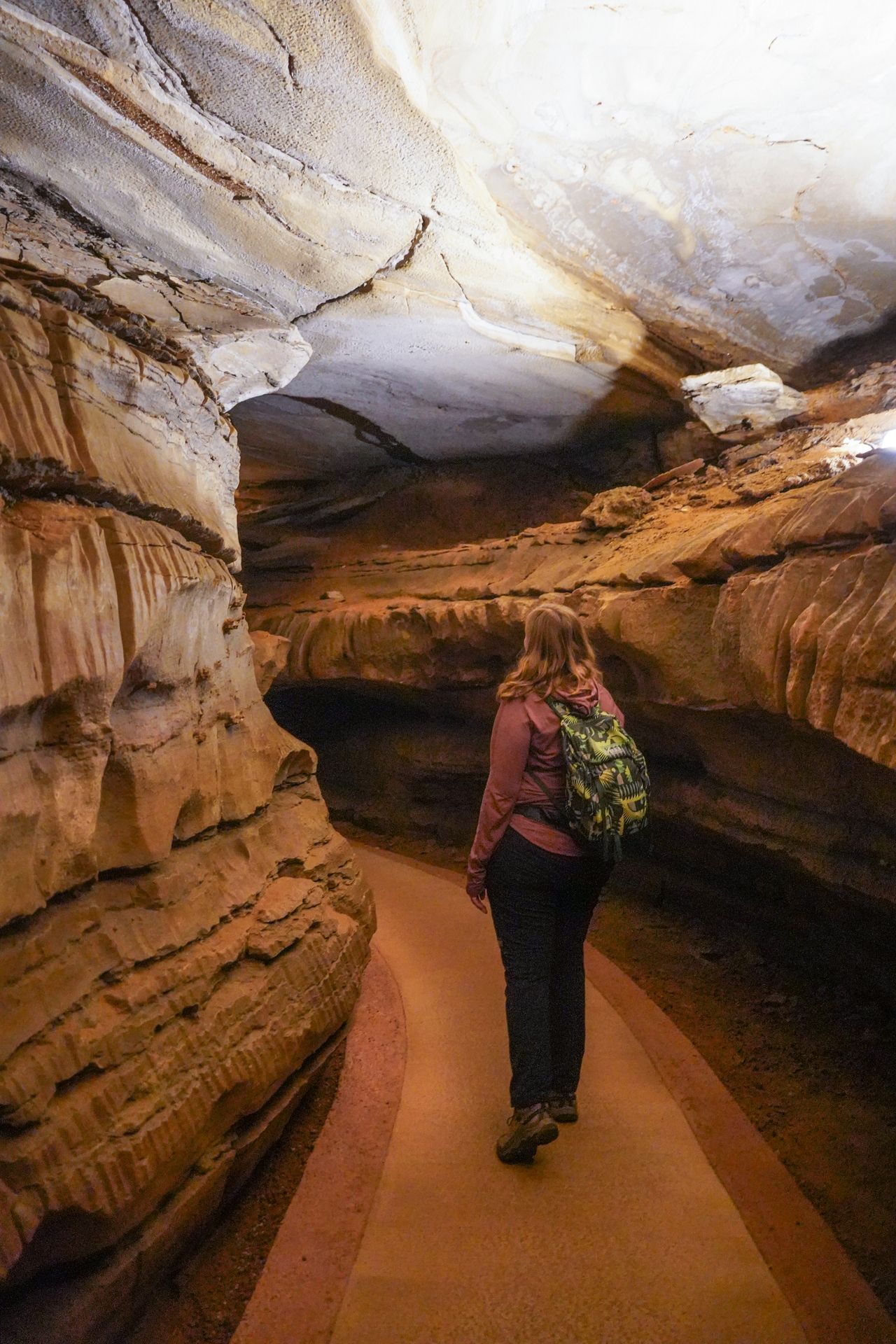 Lydia walking through a narrow section inside of Mammoth Cave