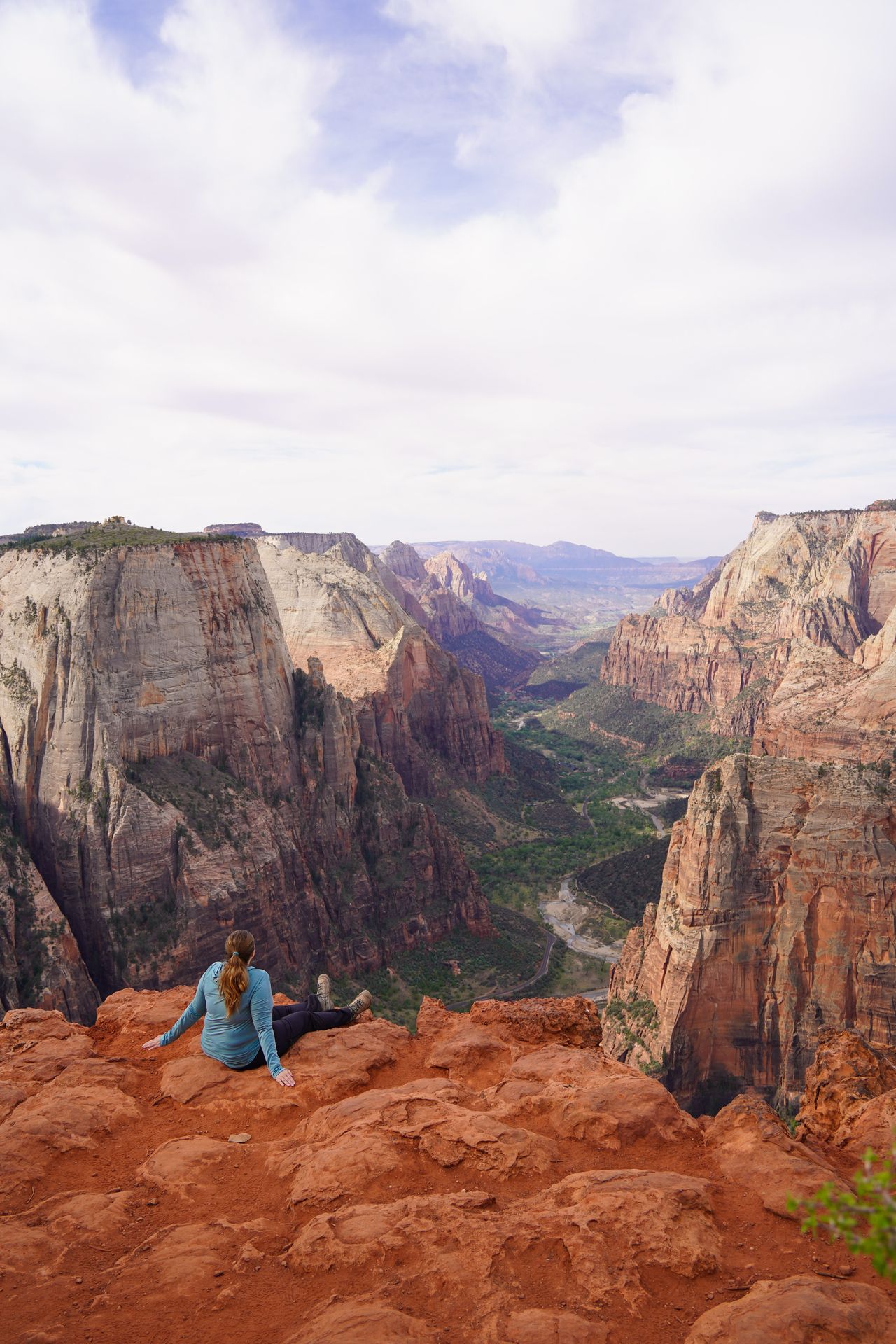 Lydia sitting and looking out into Zion Canyon on the Observation Point Trail