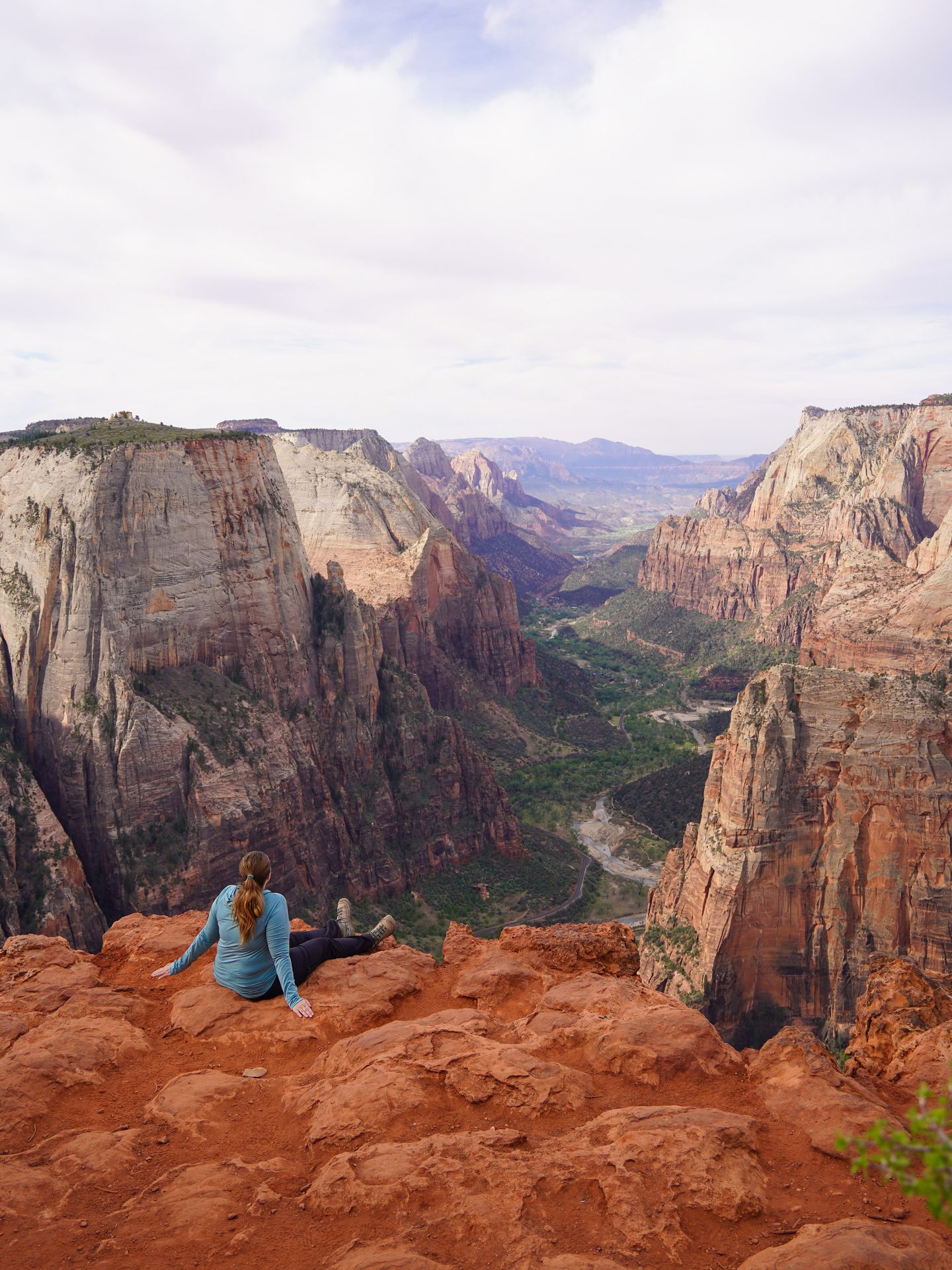 Lydia sitting and looking out into Zion Canyon on the Observation Point Trail