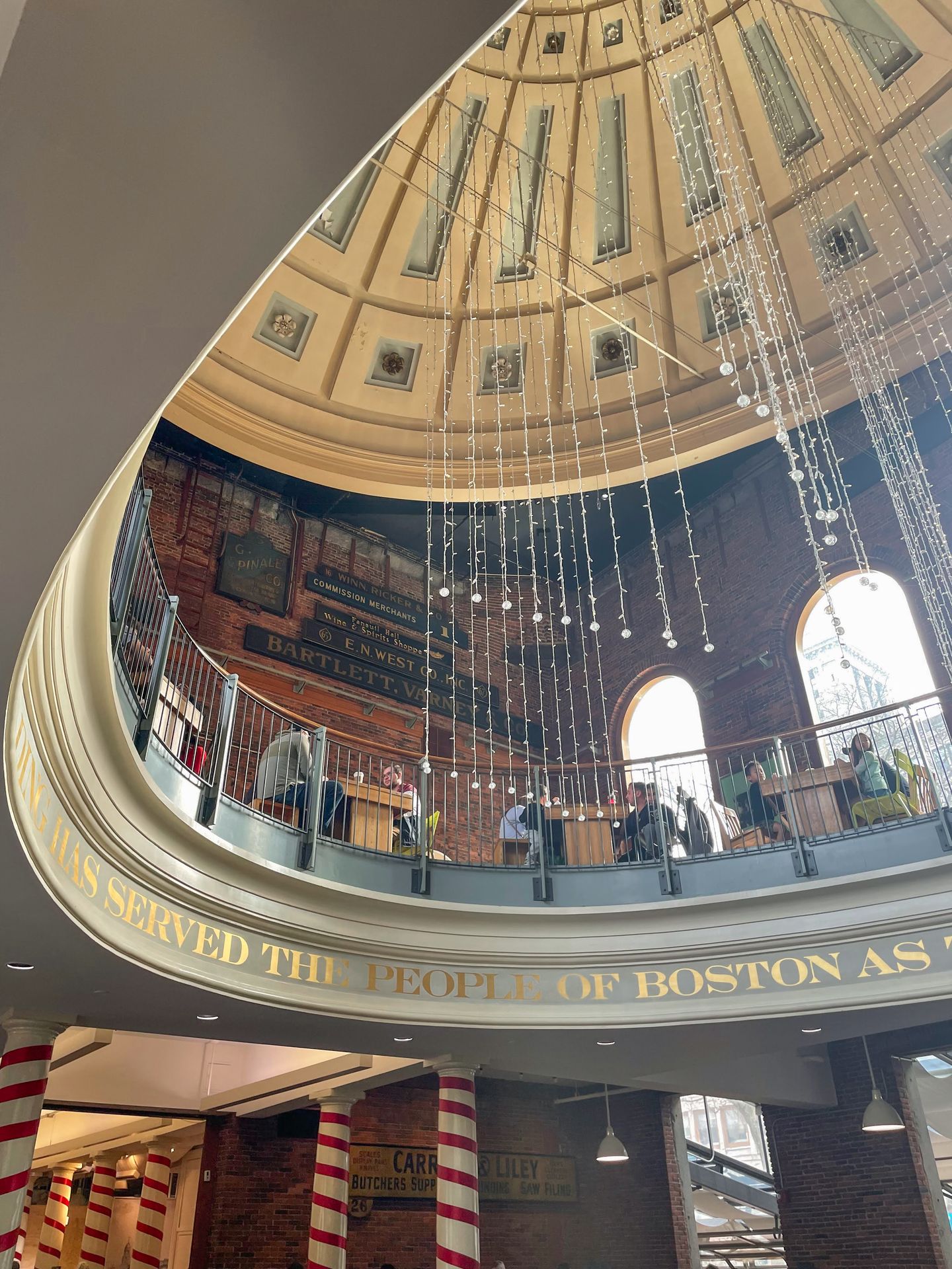A tall ceiling area with a dome inside of the Quincy Public Market.