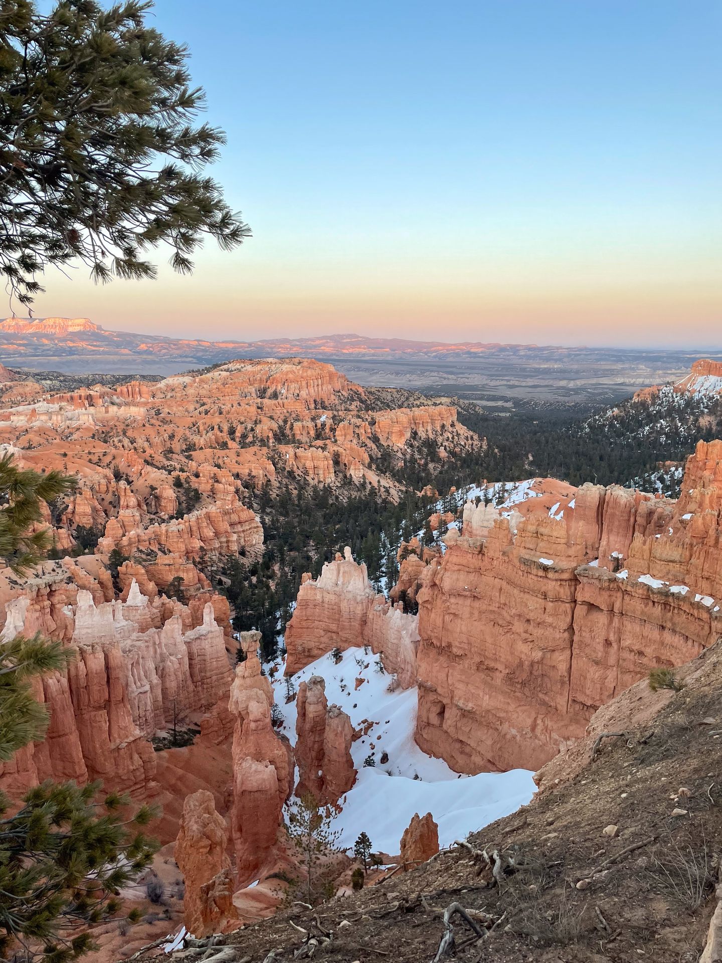 An overlook of Bryce Canyon at sunset, with a bit of snow