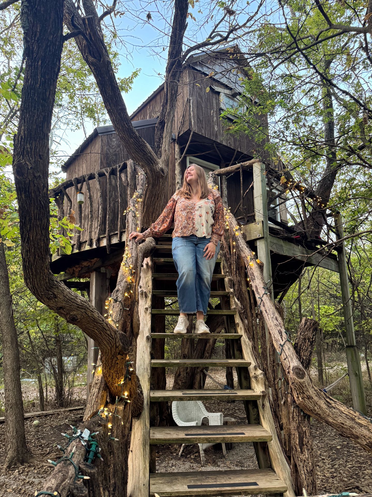 Lydia walking down the steps of the treehouse at the Barns at Timber Creek