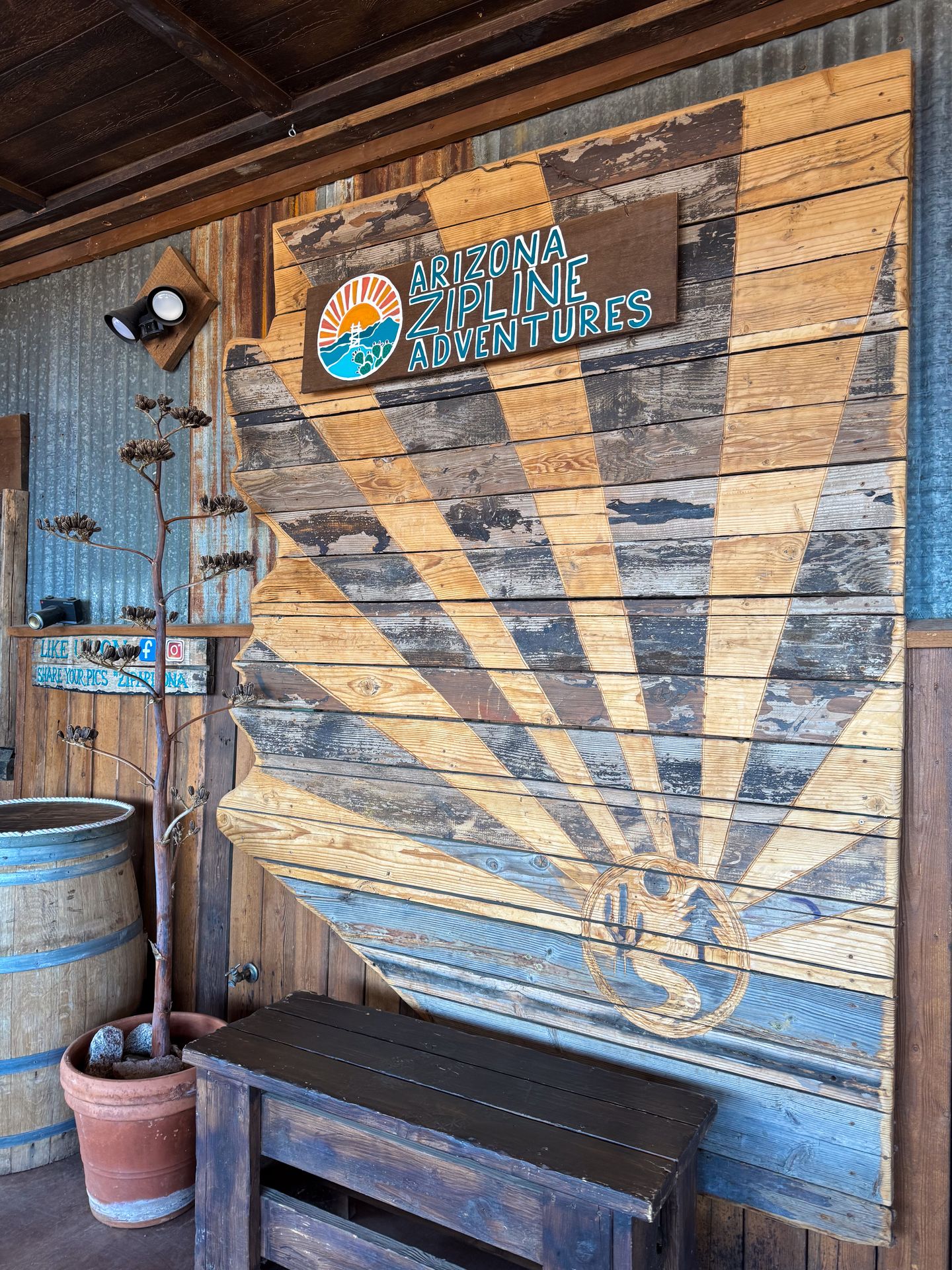 A wooden sign with the pattern of sun rays at Arizona Zipline Adventures